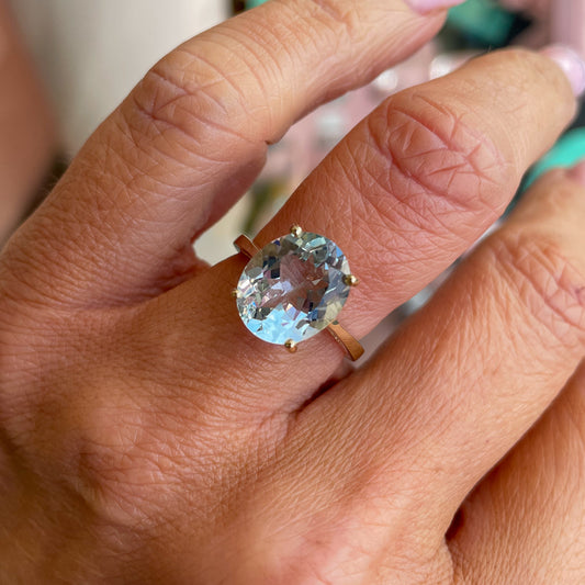 Herbert 9ct gold oval cut aquamarine ring featuring a large blue gemstone set in a polished gold band.