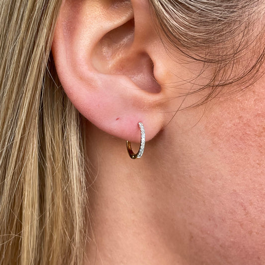 9ct gold diamond huggie hoop earrings with 0.08ct diamonds, stylish jewelry by Mark Milton, close-up of the sparkling earrings.
