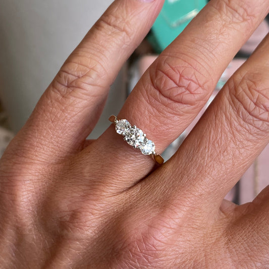 18ct gold trilogy diamond ring by FEU with a 1.00ct central diamond and two side diamonds, showcasing elegant design and sparkle.
