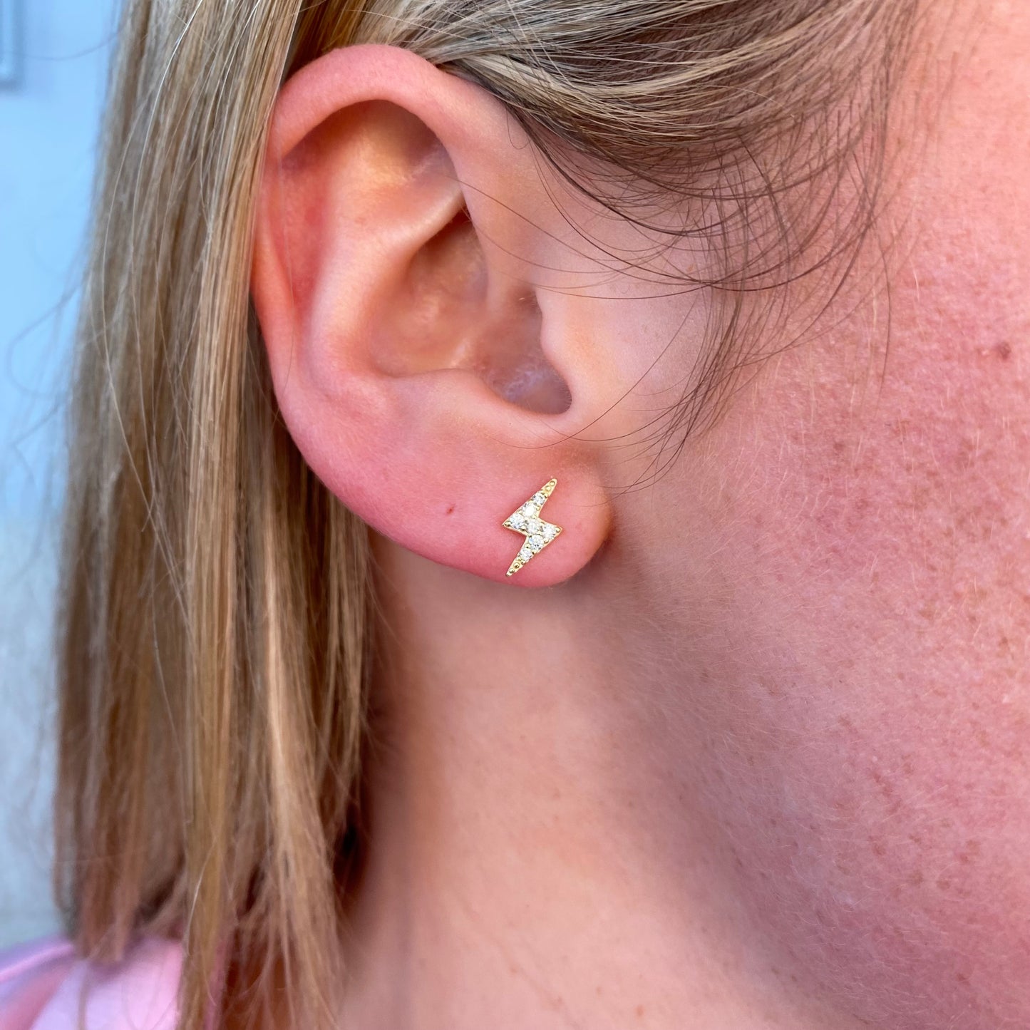 Insignia Sunshine CZ lightning bolt stud earrings featuring sparkling cubic zirconia and silver-tone metal on a white background.