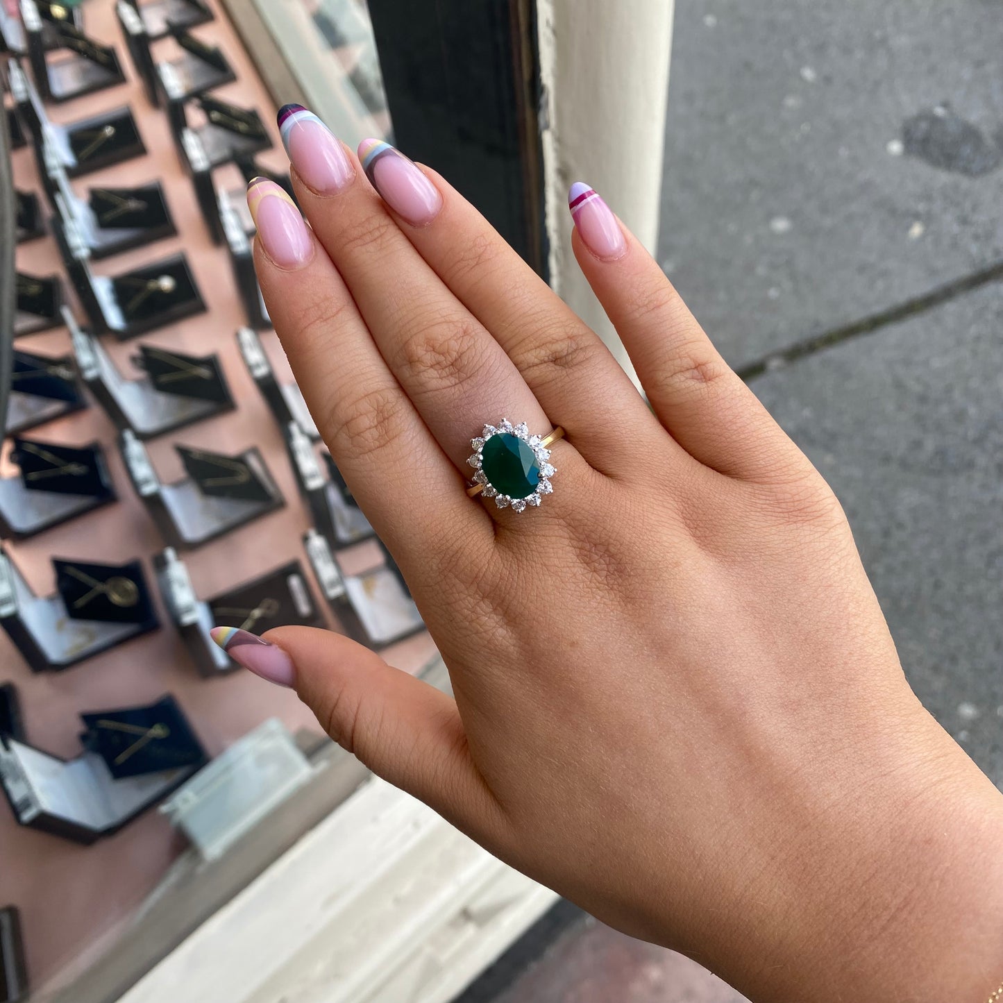 9ct gold created emerald and CZ oval cluster ring with intricate design, showcasing vibrant green stones and sparkling accents.