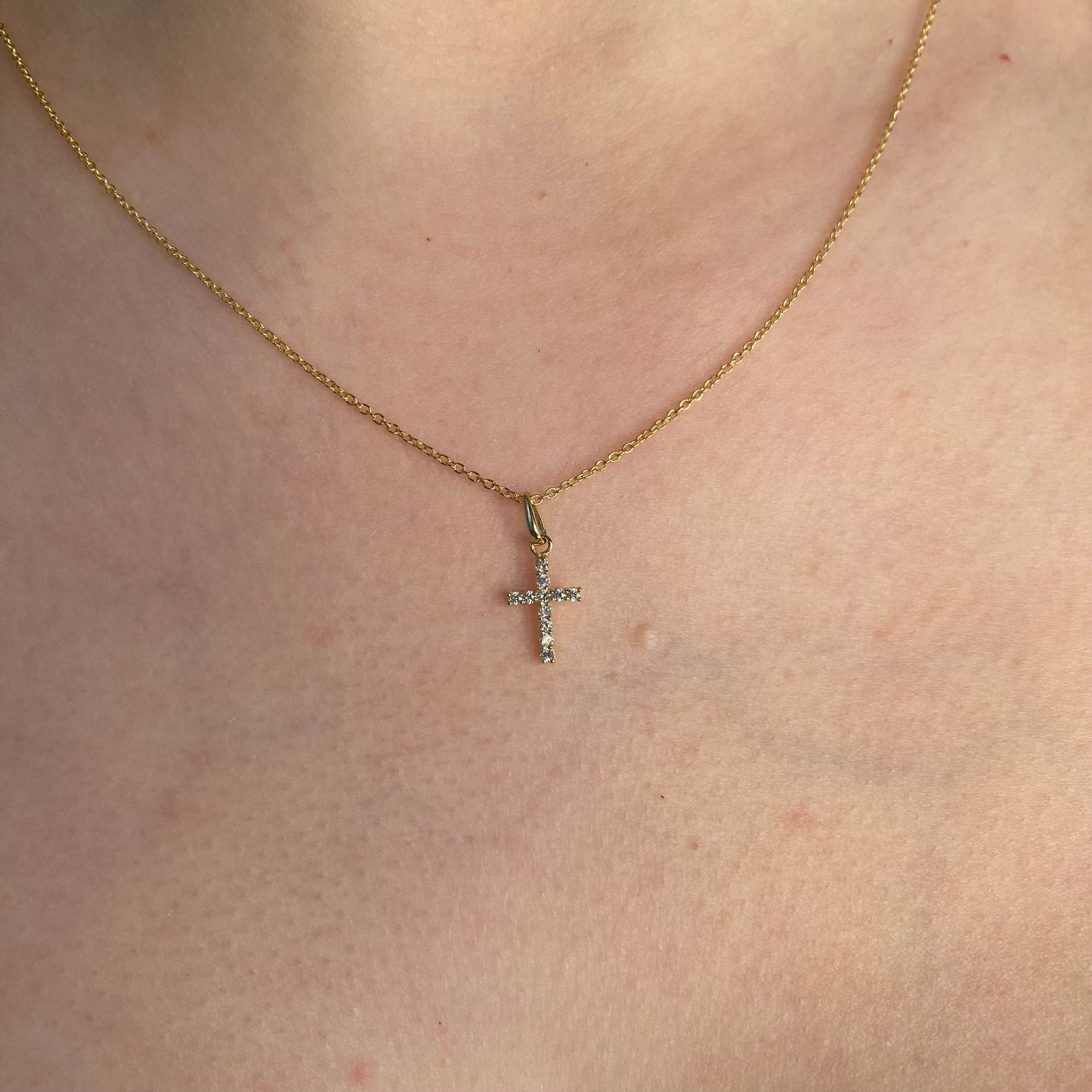 Tiny 9ct gold CZ cross pendant necklace by THC, featuring a delicate cross design on a fine chain.