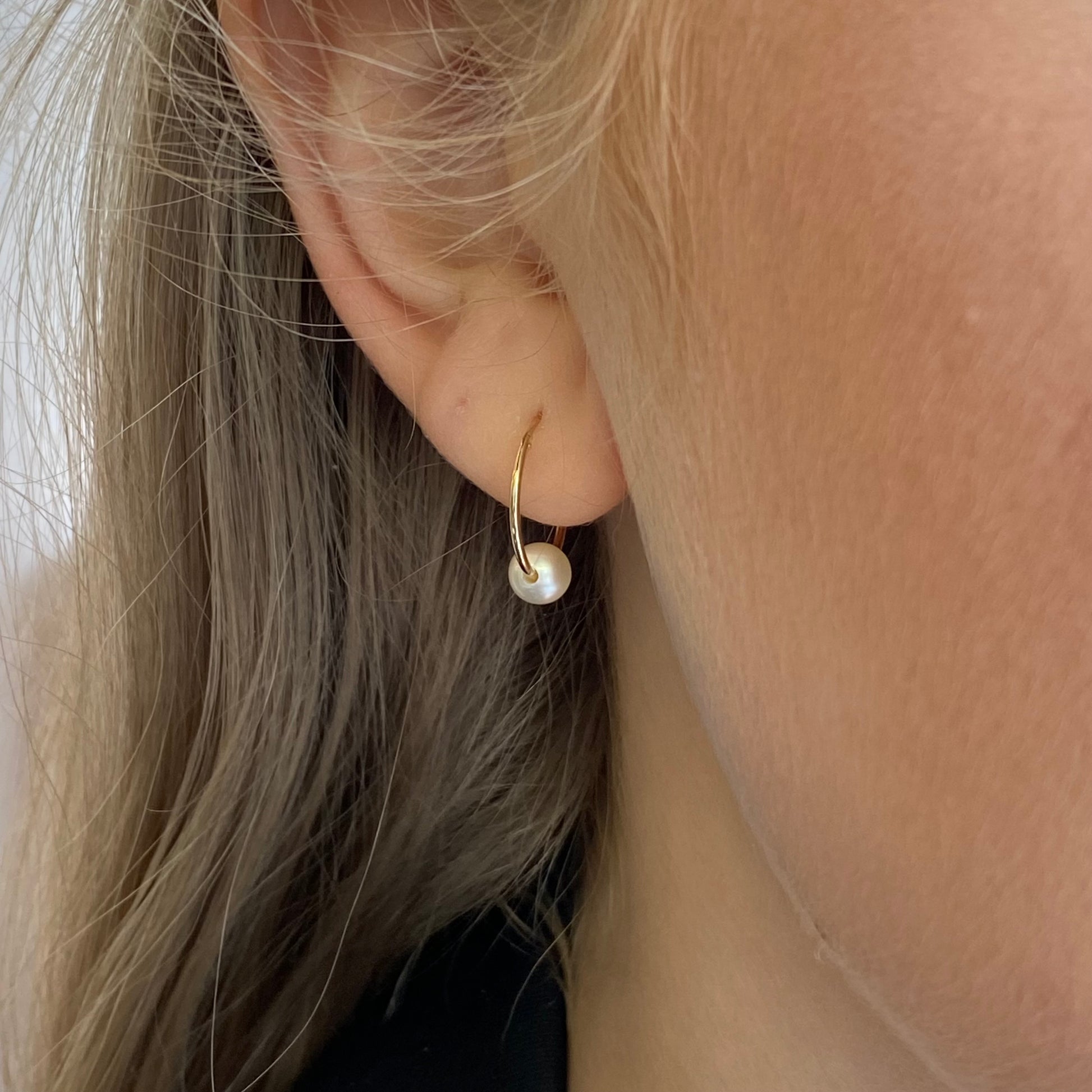 9ct gold sleeper earrings with pearl slider, featuring elegant and classic jewelry design for pierced ears.