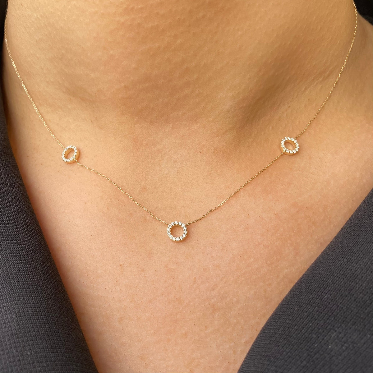 NJO 9ct gold three circle CZ necklace featuring intertwined gold and cubic zirconia accents on a delicate chain