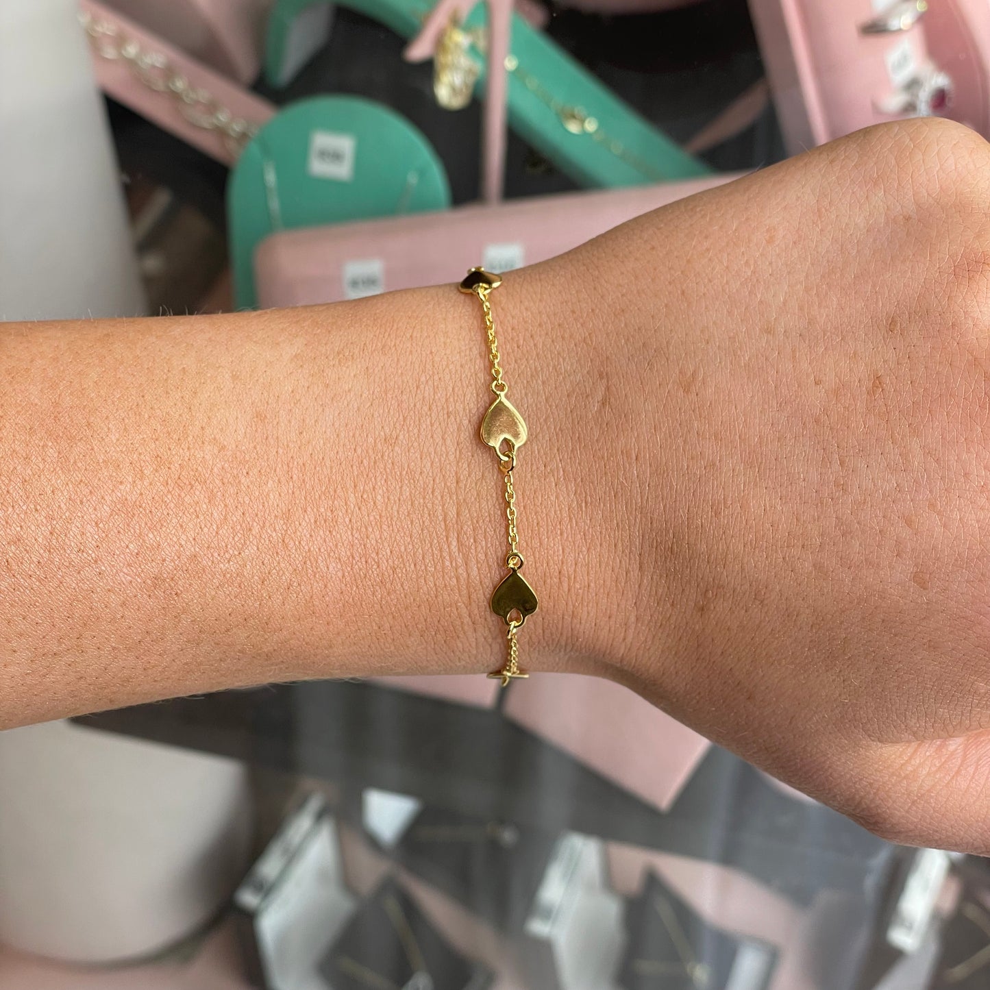 CME Sunshine Heart Disc bracelet featuring a gold-tone heart-shaped charm on a delicate chain.