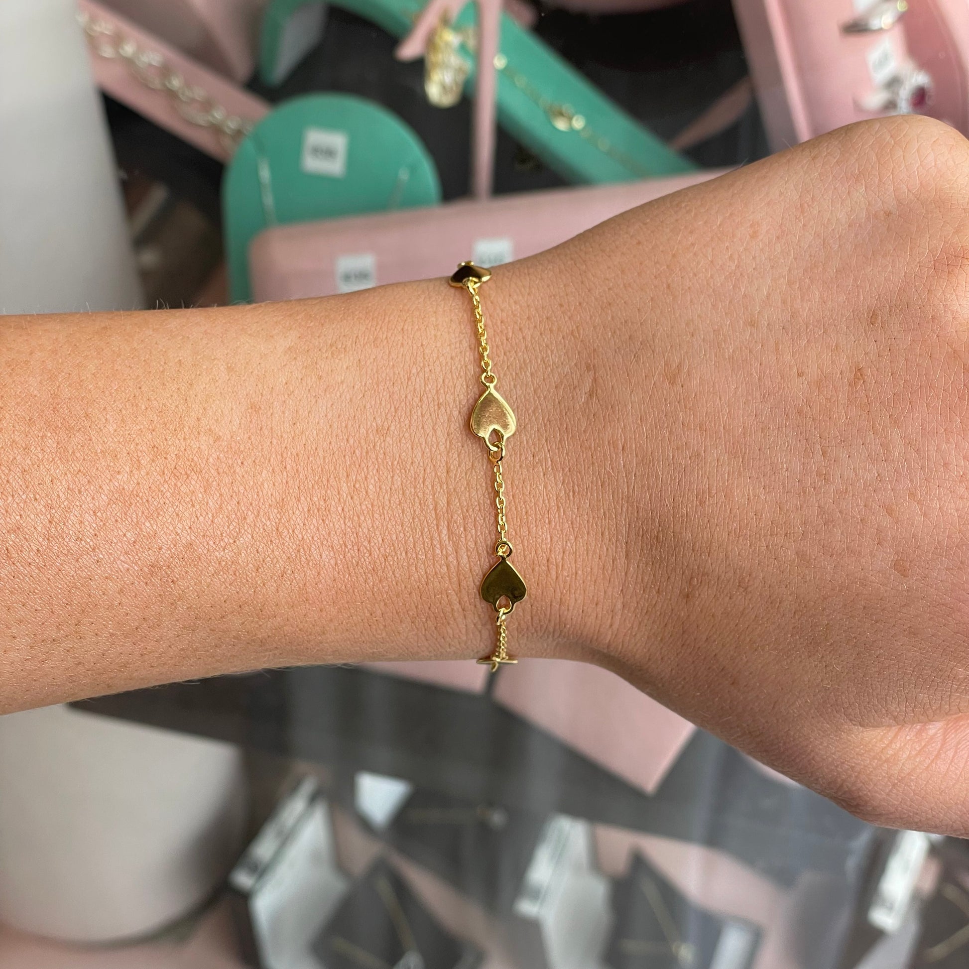 CME Sunshine Heart Disc bracelet featuring a gold-tone heart-shaped charm on a delicate chain.