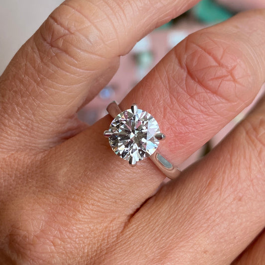TCA platinum solitaire engagement ring featuring a 3.01ct certified lab diamond, showcasing a sleek and elegant design.