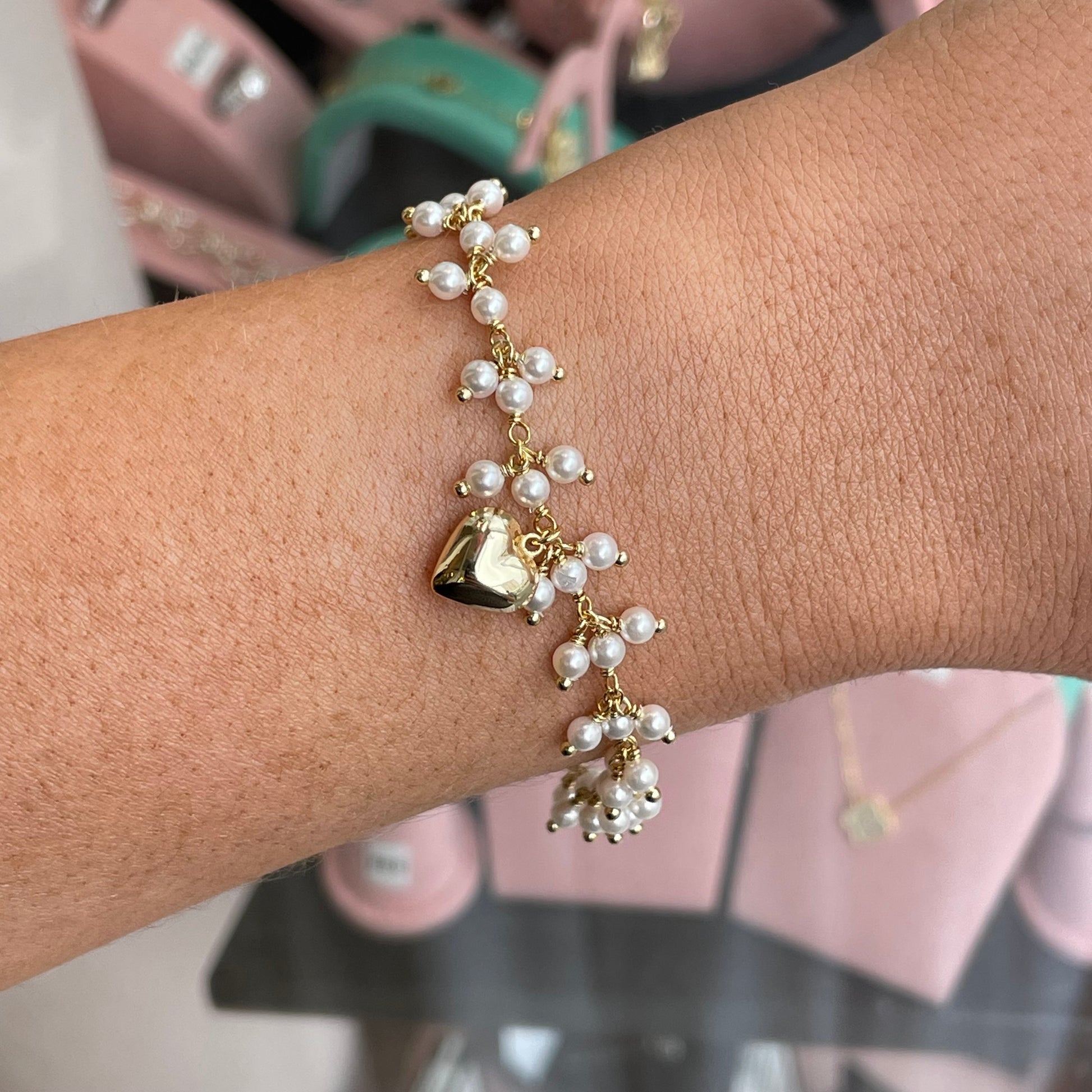 CME Sunshine faux pearl and heart bracelet with gold-tone accents, featuring a delicate chain and charming heart pendant.