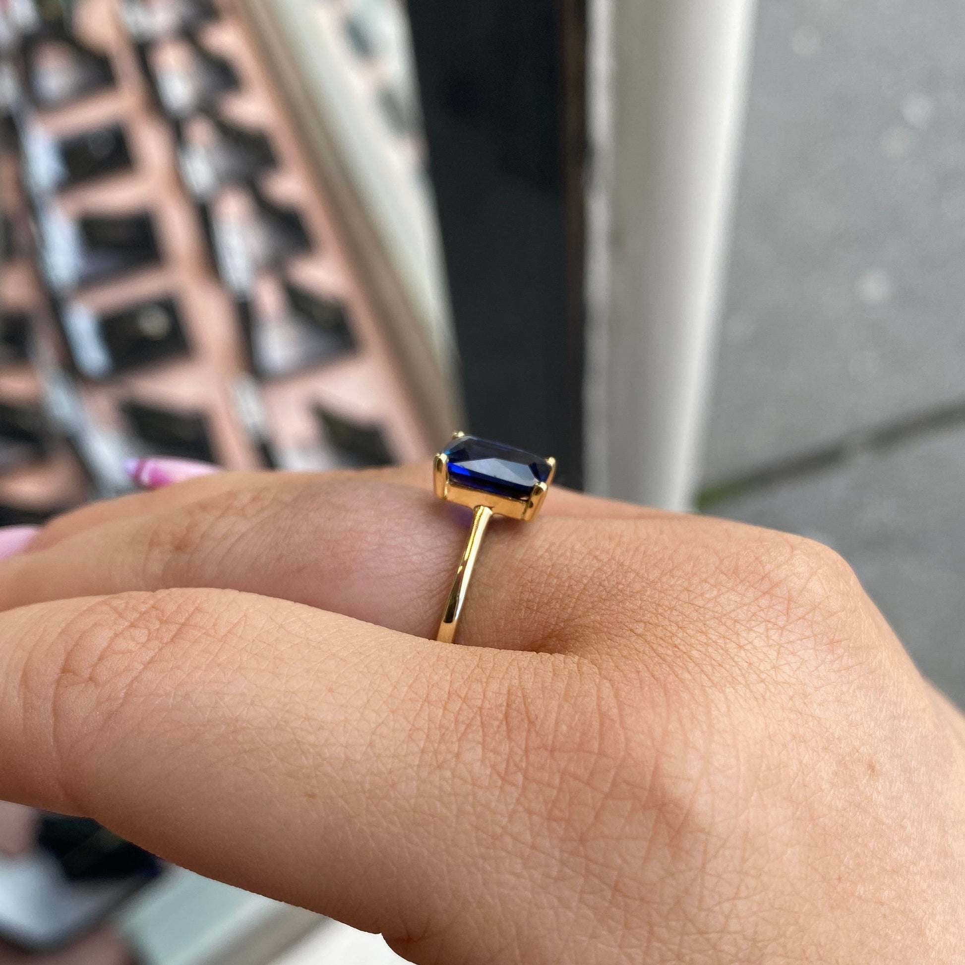 9ct gold created sapphire solitaire ring with a central blue sapphire gemstone set in a polished gold band
