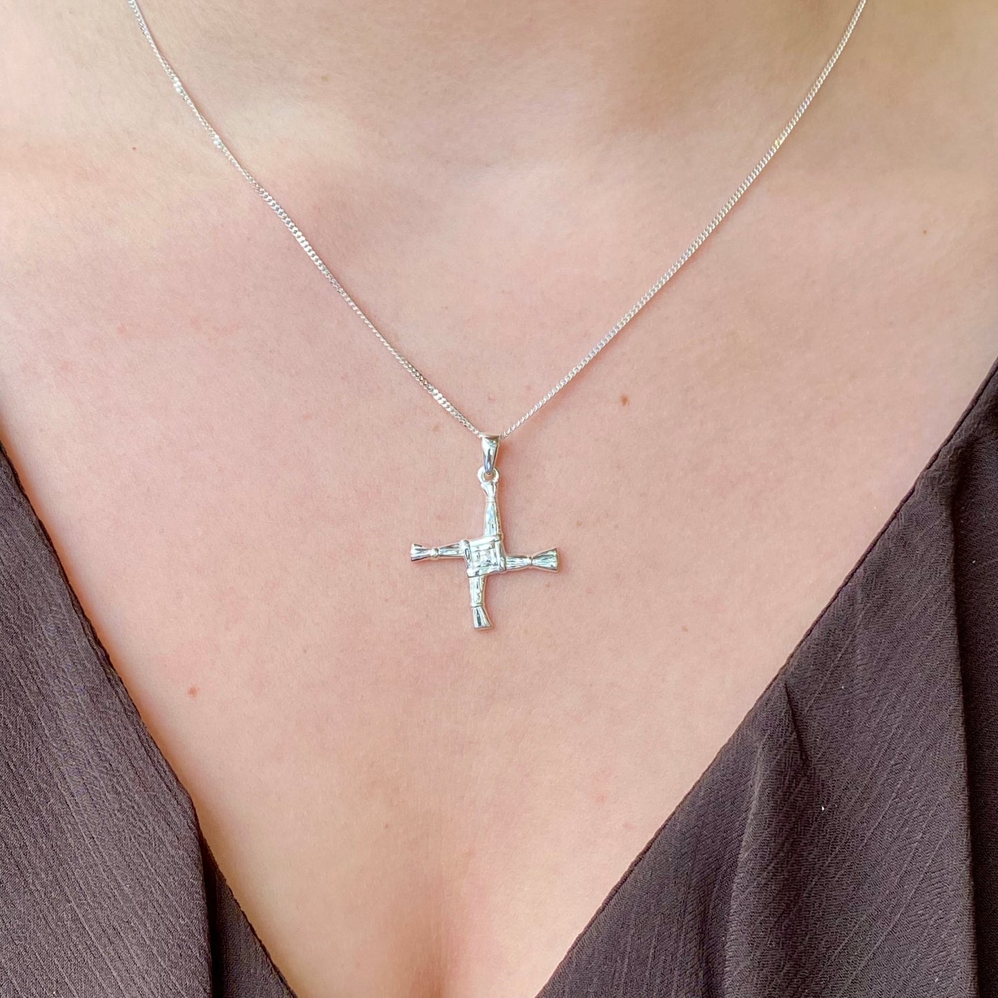 Medium silver St Bridget cross necklace by Clandela, featuring intricate detailing and a delicate chain.