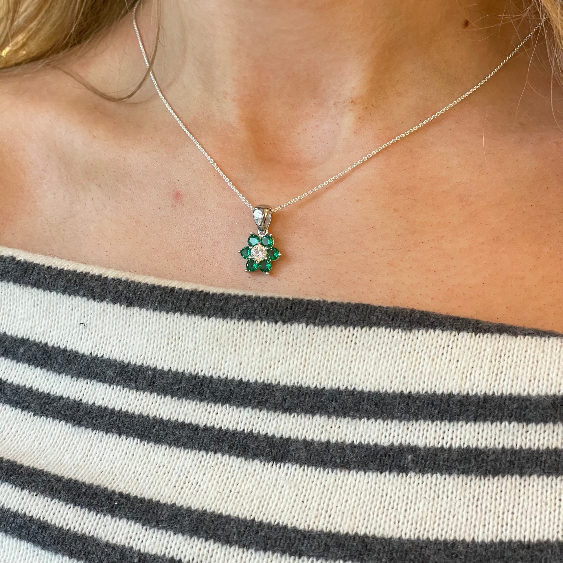 Silver Flower Cluster CZ Pendant Necklace with emerald green accents on 18-inch chain by Comero, featuring floral design and sparkling gemstones.