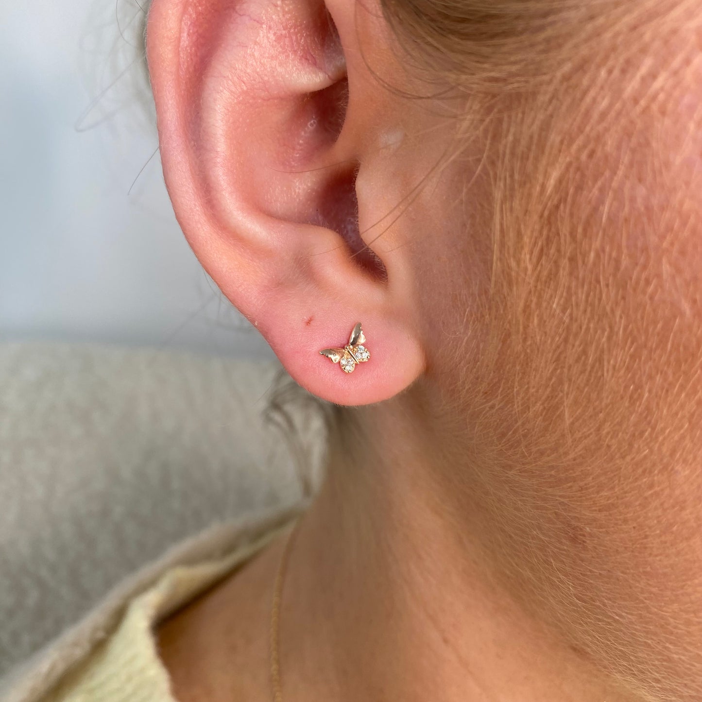 Sunshine CZ butterfly stud earrings for kids by Comero, featuring sparkling cubic zirconia and delicate butterfly design.
