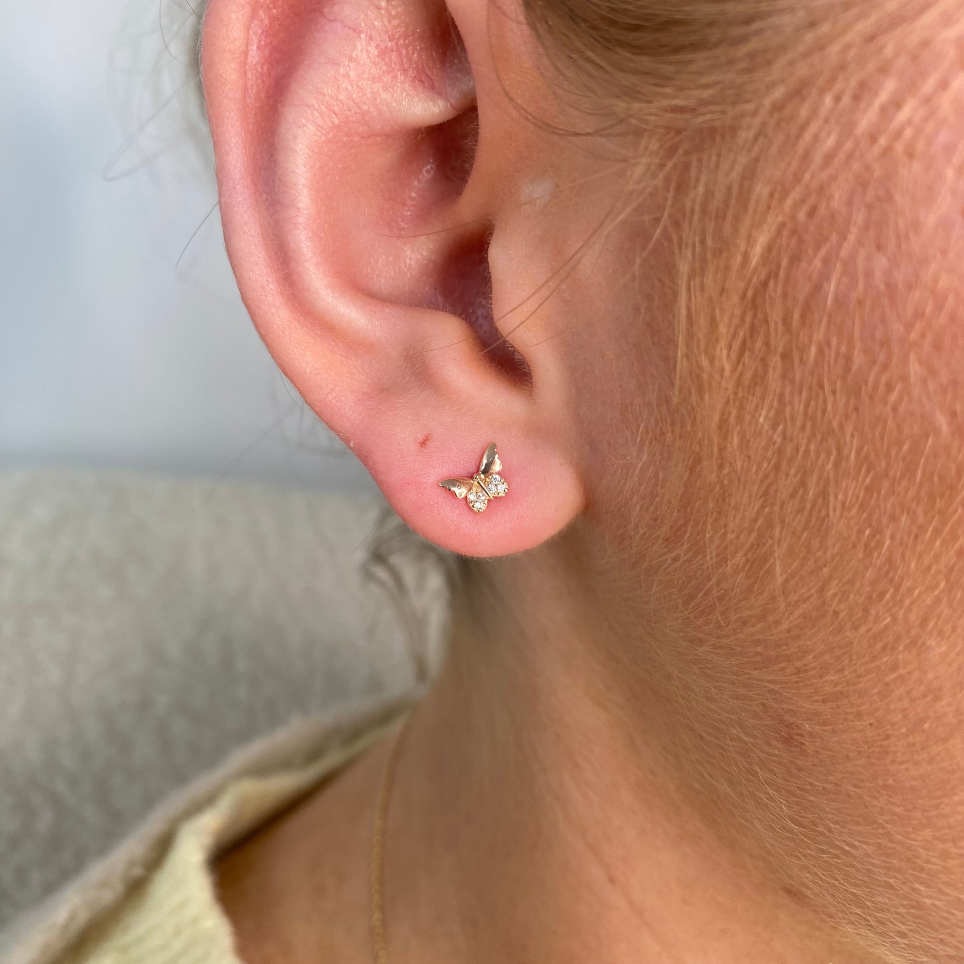 Sunshine CZ butterfly stud earrings for kids by Comero, featuring sparkling cubic zirconia and delicate butterfly design.