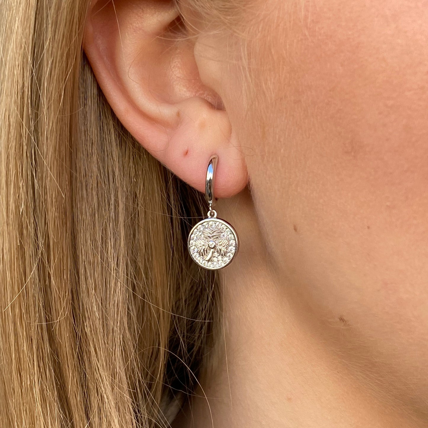 Silver CZ shamrock charm hoop earrings by Comero featuring sparkling cubic zirconia accents and a stylish, lightweight design.
