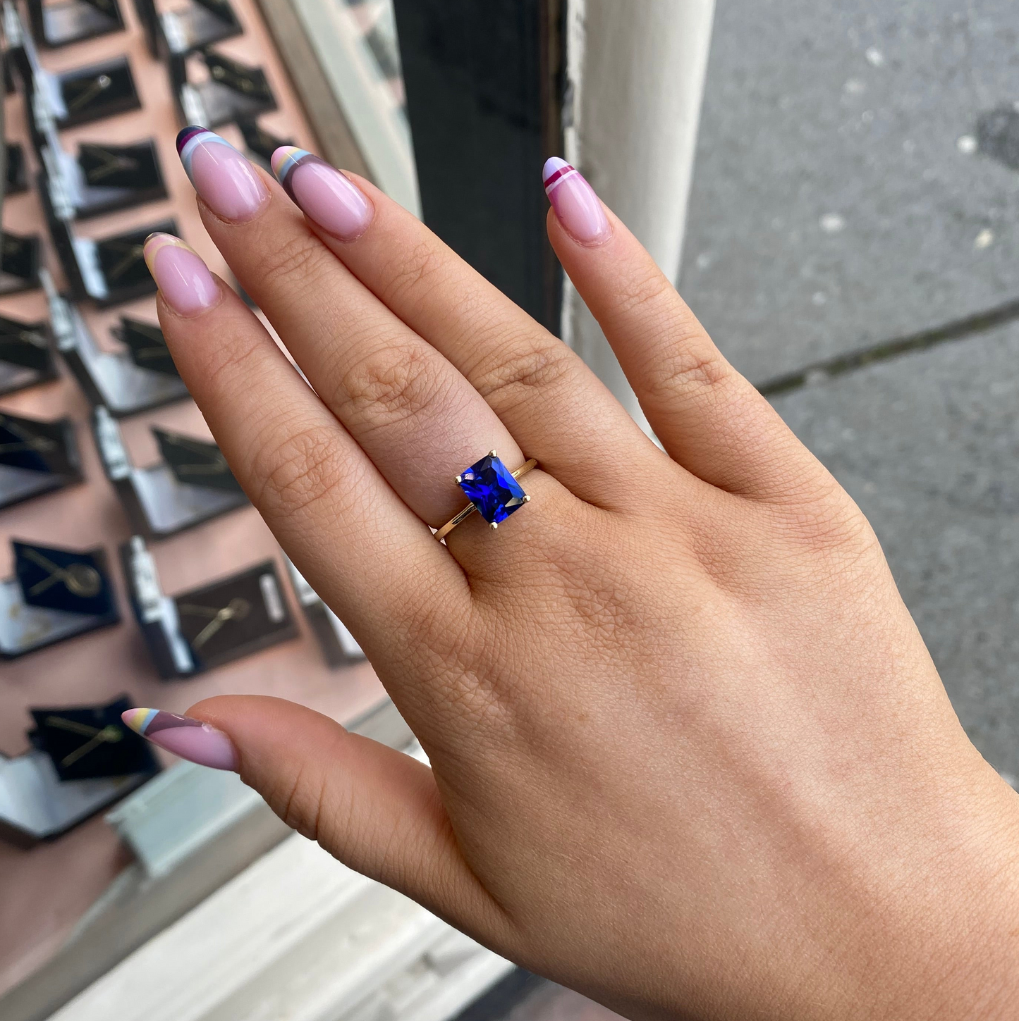 9ct gold created sapphire solitaire ring featuring a central blue sapphire gemstone set in a classic gold band.
