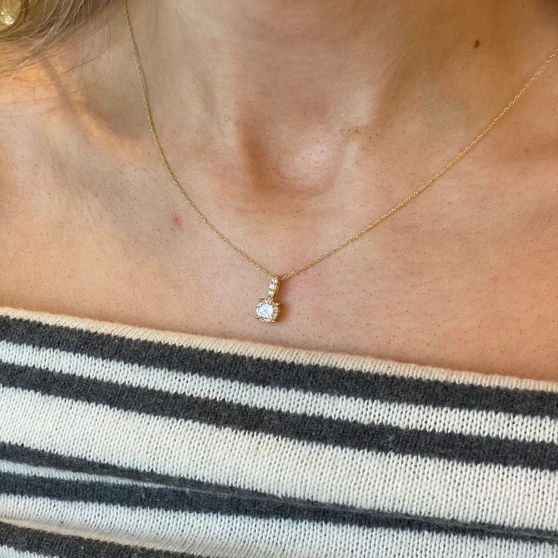NJO 9ct gold claw set CZ necklace featuring a 6mm sparkling cubic zirconia pendant on a delicate chain.