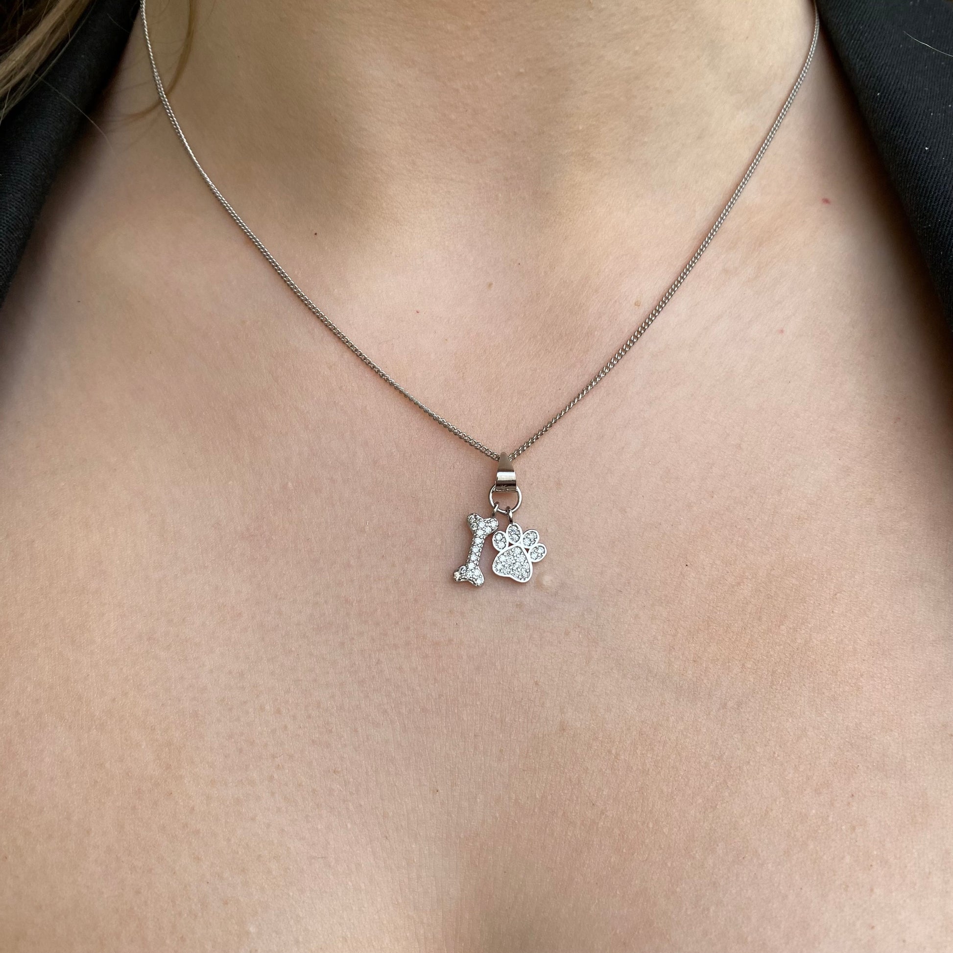 Silver Pretty CZ dog paw and bone necklace by Insignia featuring sparkling cubic zirconia accents on a delicate chain.