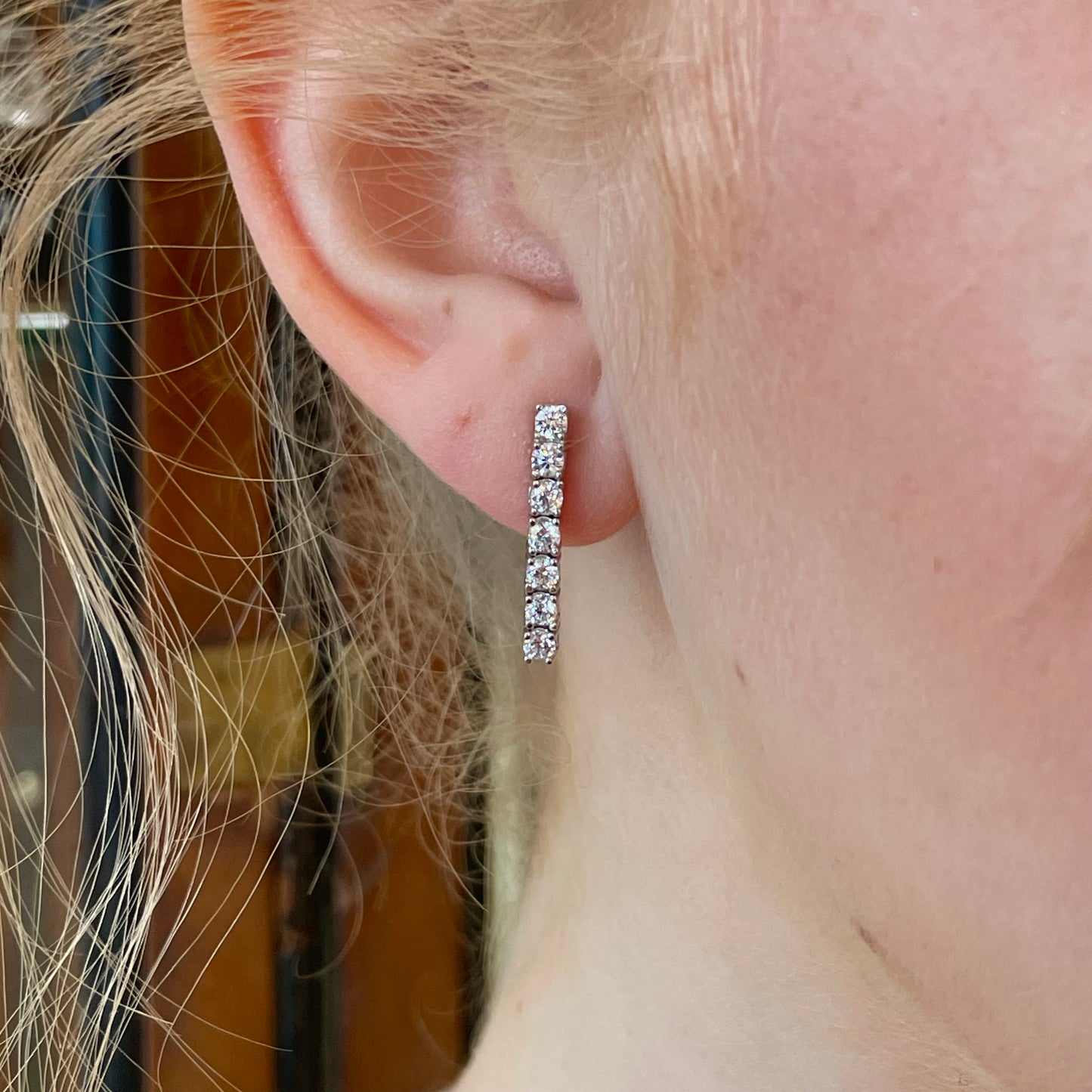 Silver graduated CZ tennis earrings by Comero featuring sparkling cubic zirconia stones in a sleek, elegant design.