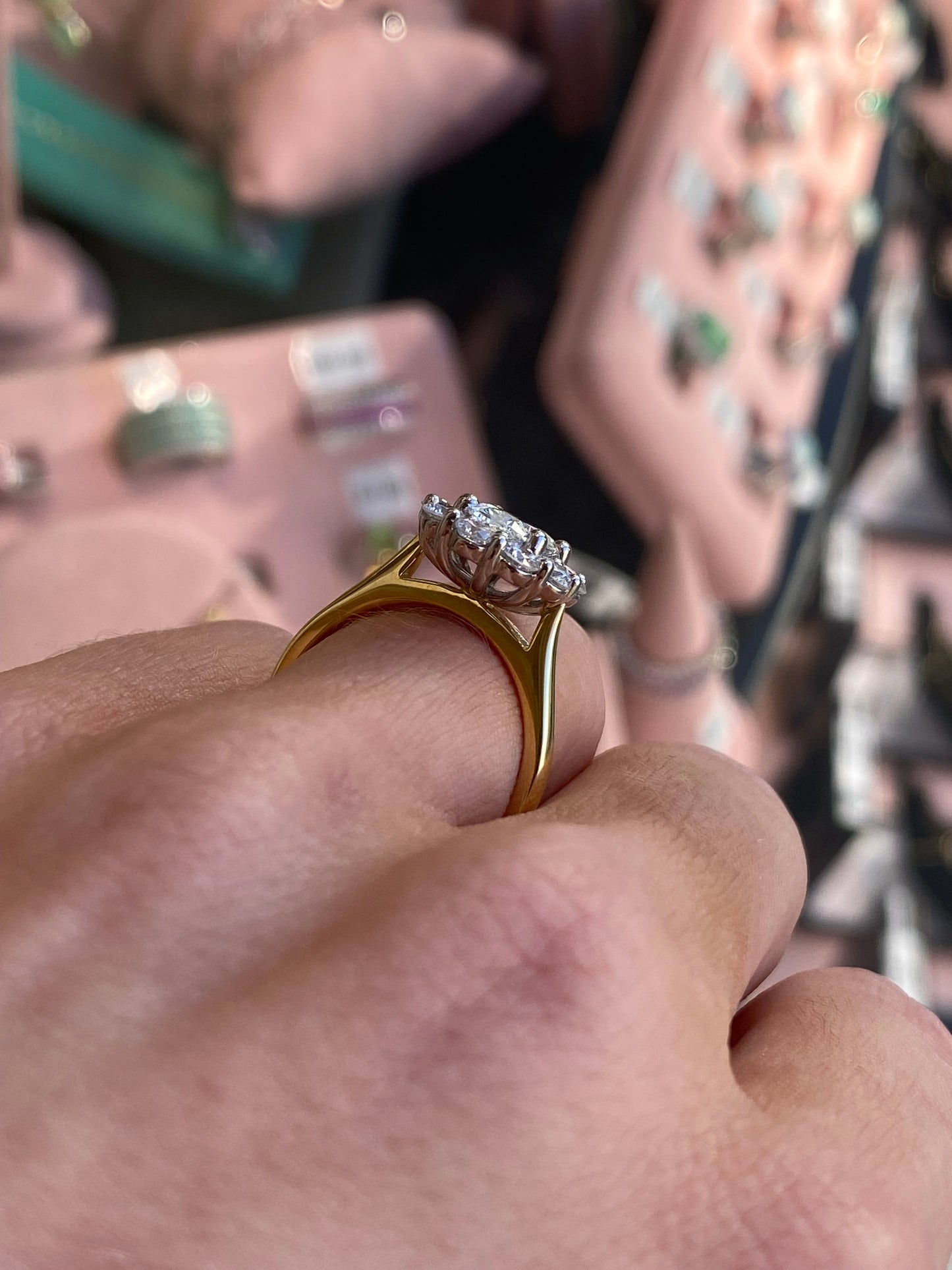 Prima 18ct gold oval cluster engagement ring with Certificated Lab, featuring a detailed design and sparkling gemstone accents.