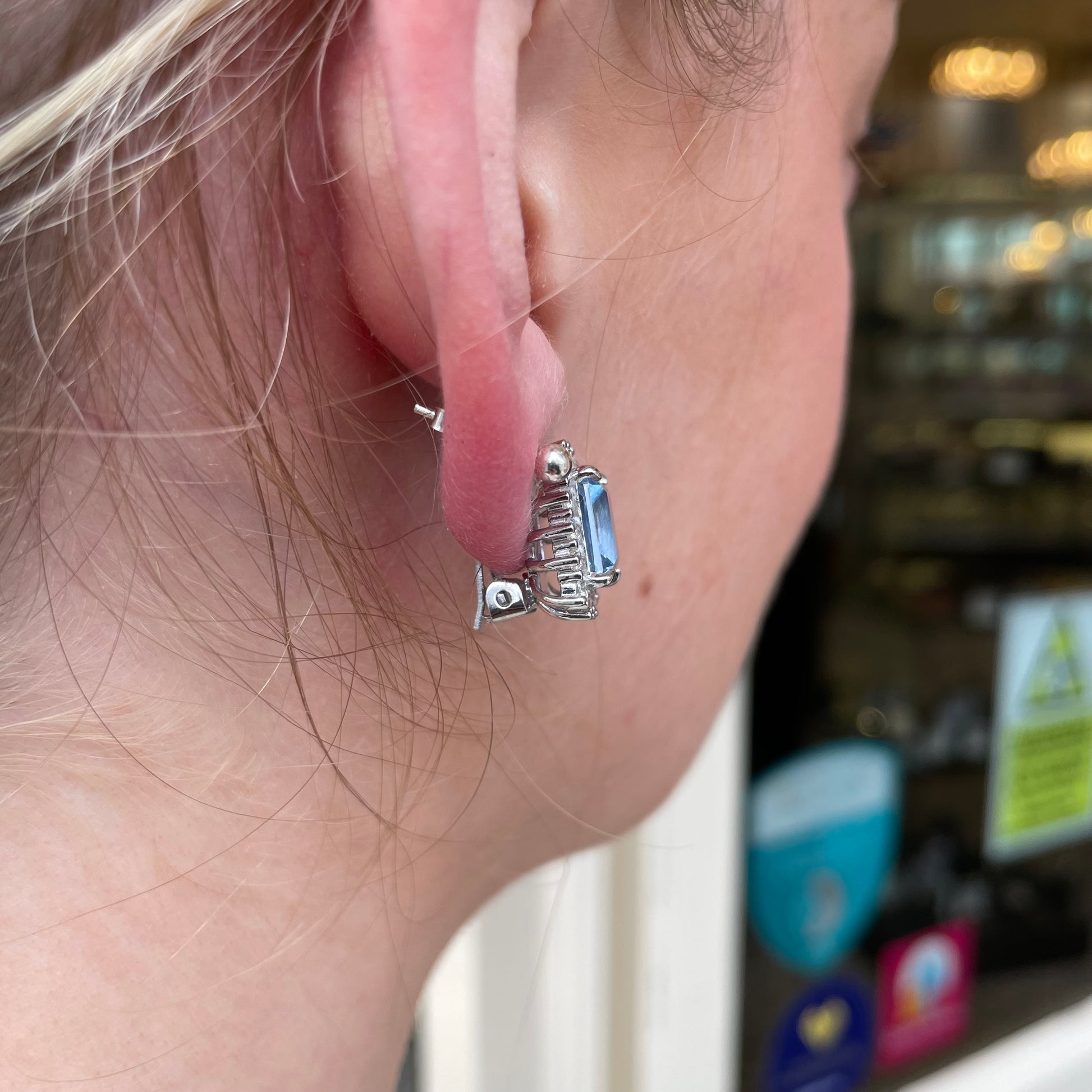 Silver clip-on earrings with 10x8mm Aqua Spinel and CZ stones, featuring a stylish and elegant design by Comero.