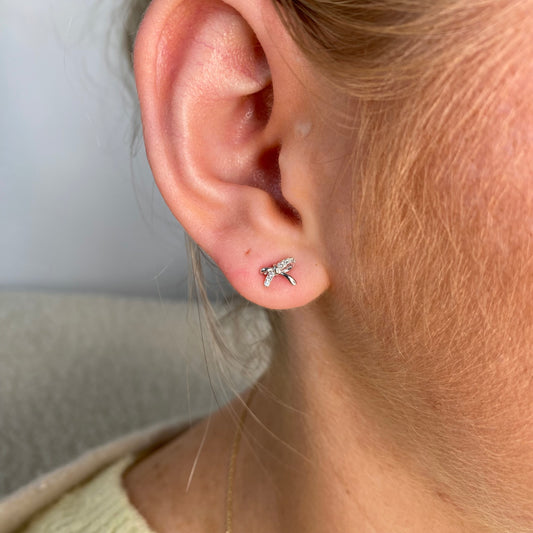 Silver CZ kiss stud earrings for kids by Comero, featuring sparkling cubic zirconia and a cute kiss design.