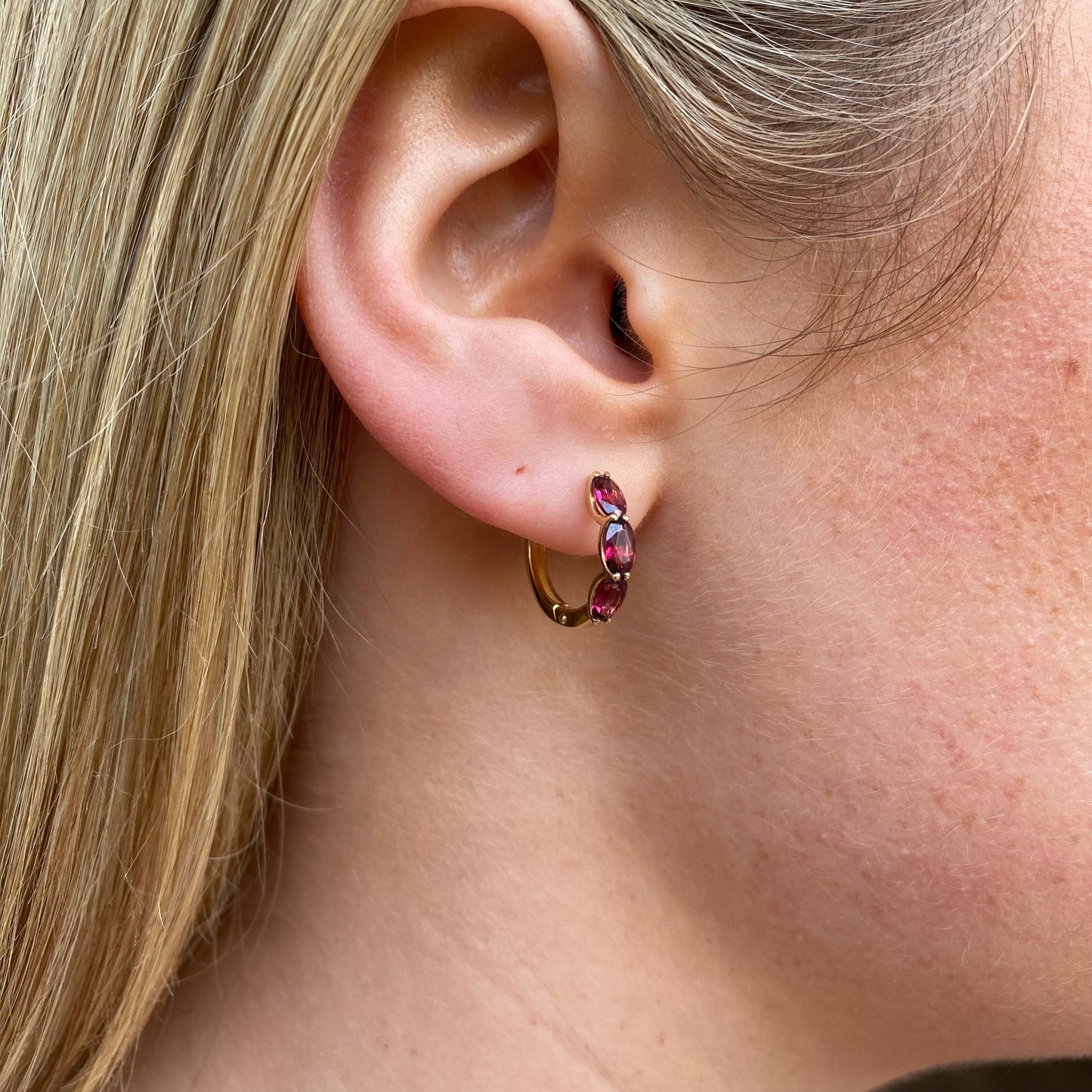 9ct gold garnet huggie hoop earrings by Mark Milton, 15mm size, featuring vibrant red garnet stones and a sleek hoop design.