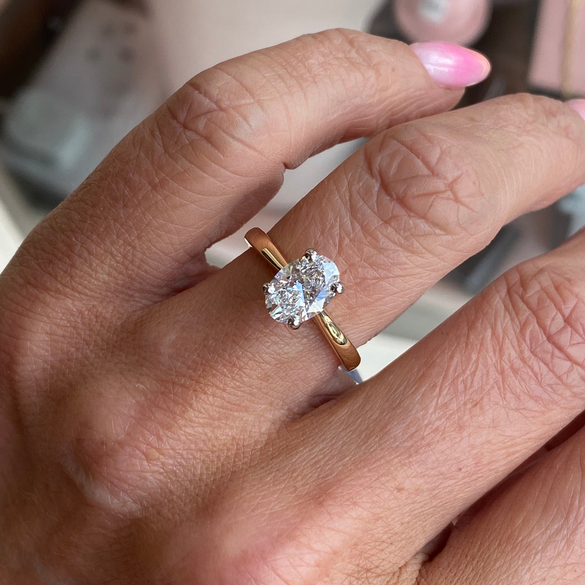 Prima 18ct gold oval solitaire engagement ring with a 1.51ct certified diamond, showcasing a sleek and elegant design.