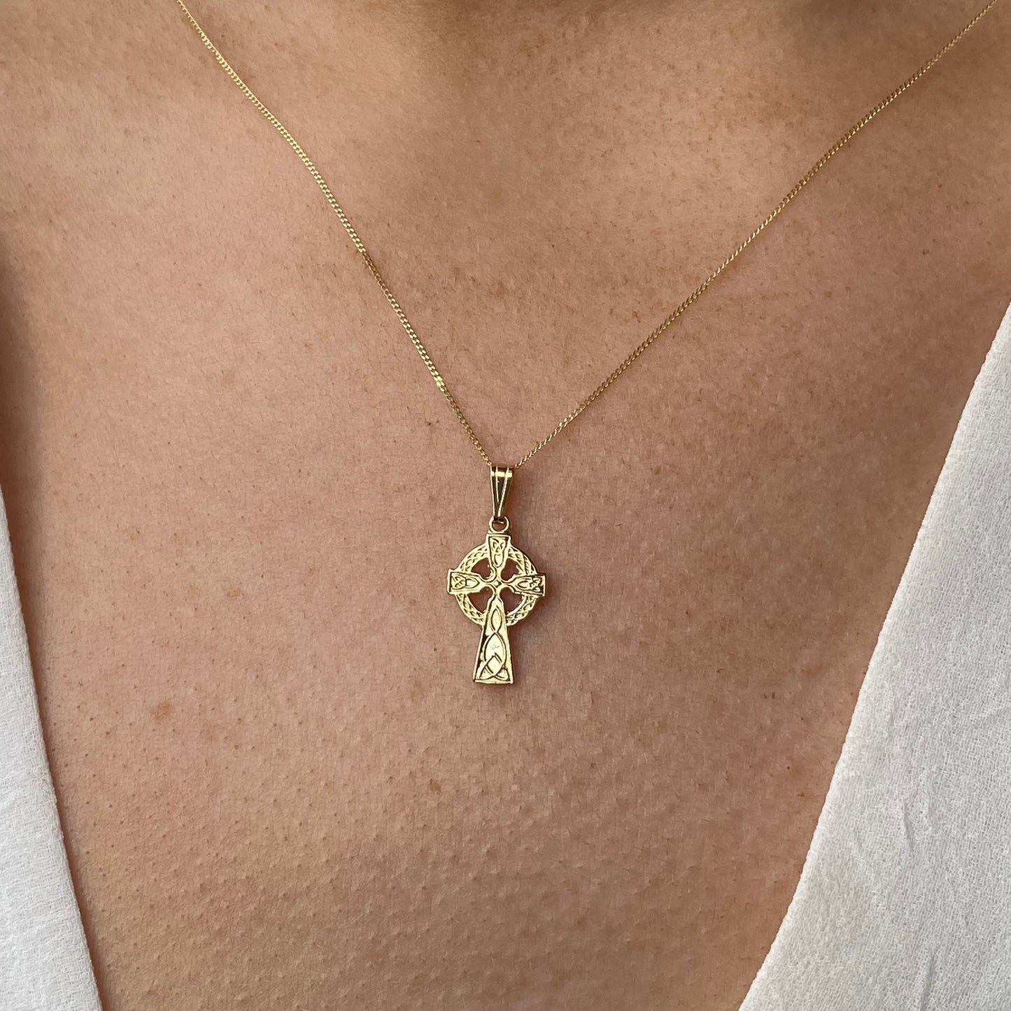 Mini 10ct gold Celtic cross necklace by Facet featuring a detailed Celtic cross pendant on a delicate chain.
