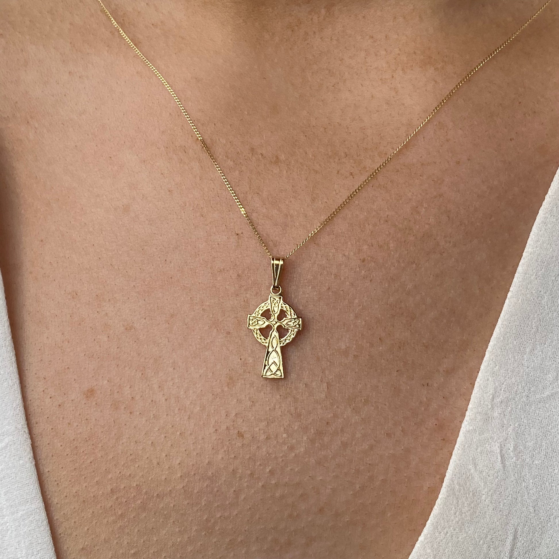 Mini 10ct gold Celtic cross necklace by Facet featuring a detailed Celtic cross pendant on a delicate chain.