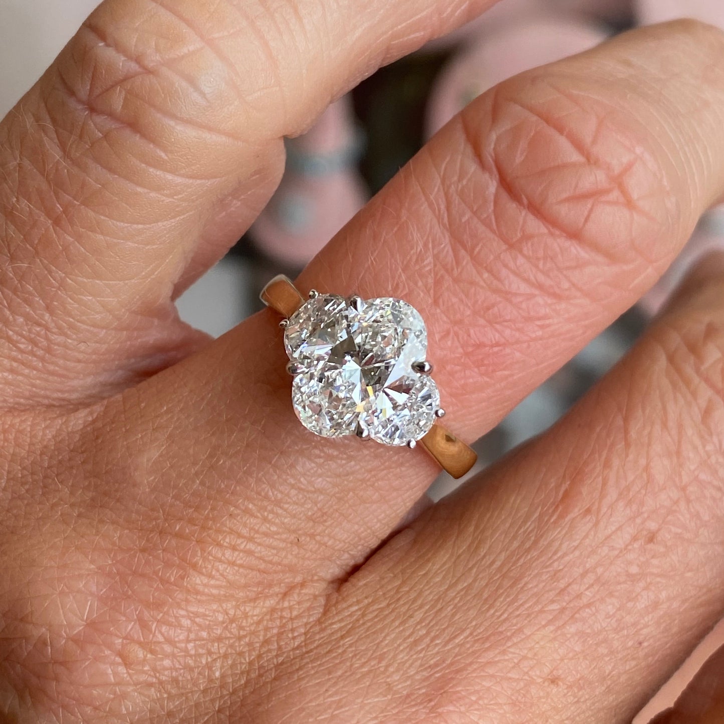 18ct gold trilogy engagement ring by TCA featuring lab-certified 2.52ct center diamond with side stones.