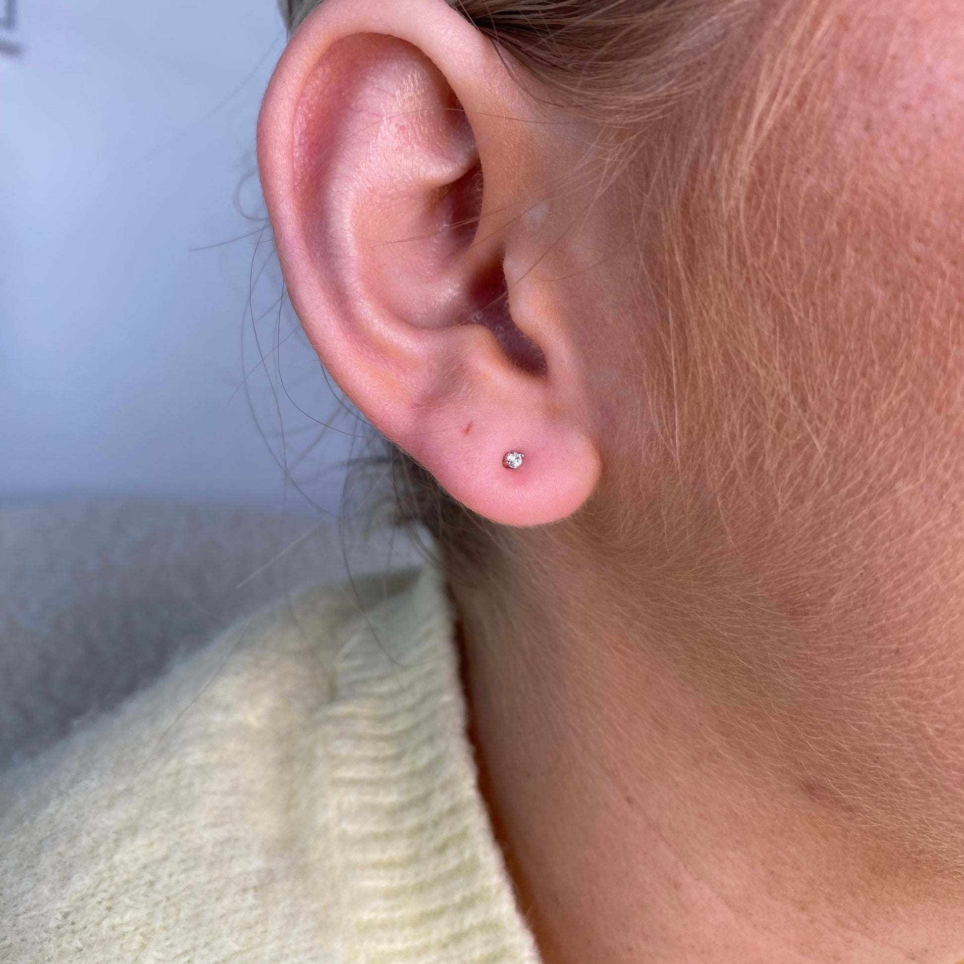 Silver Nano CZ stud earrings for kids featuring sparkling cubic zirconia stones, designed by Comero.