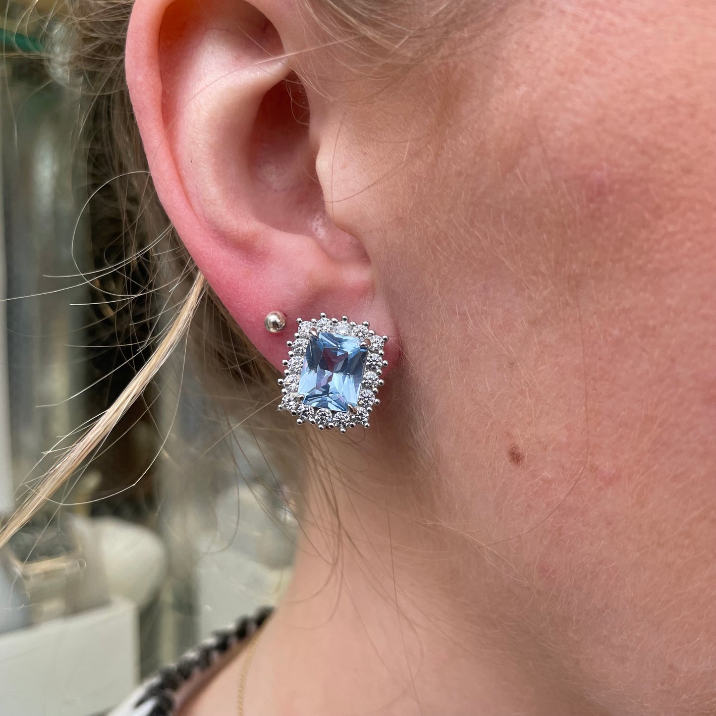 Silver clip-on earrings featuring 10x8mm aqua spinel and CZ stones, showcasing elegant jewelry design.