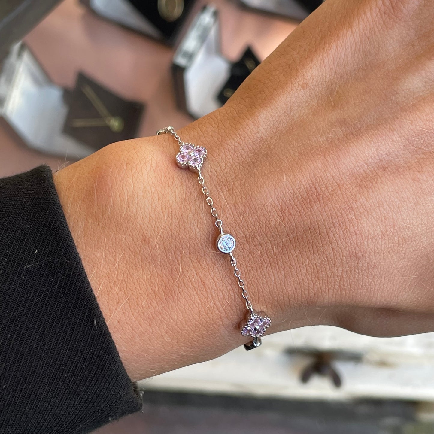 Silver CZ quatrefoil bracelet with baby pink accents by Insignia, featuring a delicate design and sparkling gemstone details.