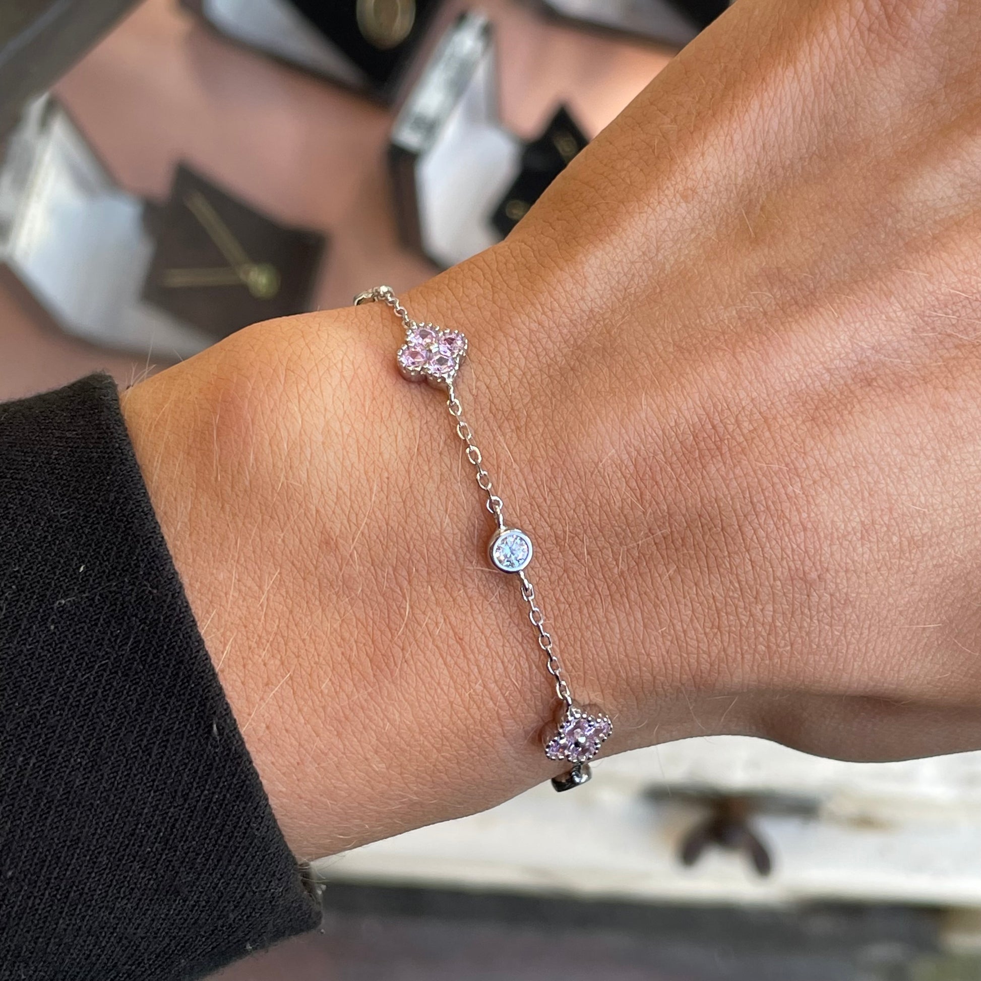Silver CZ quatrefoil bracelet with baby pink accents by Insignia, featuring a delicate design and sparkling gemstone details.