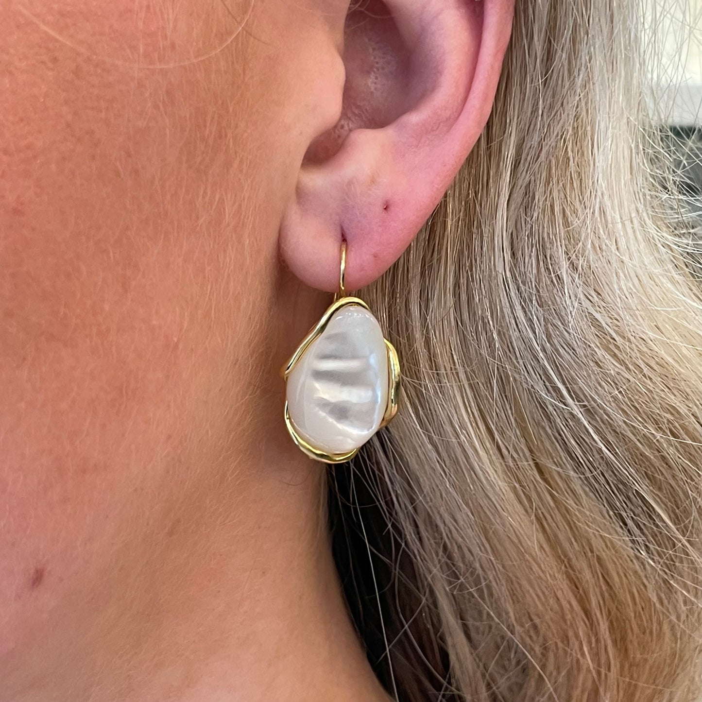 Bruno mother of pearl drop earrings, 31mm by 17mm, featuring smooth iridescent pearl stones on elegant silver hooks.