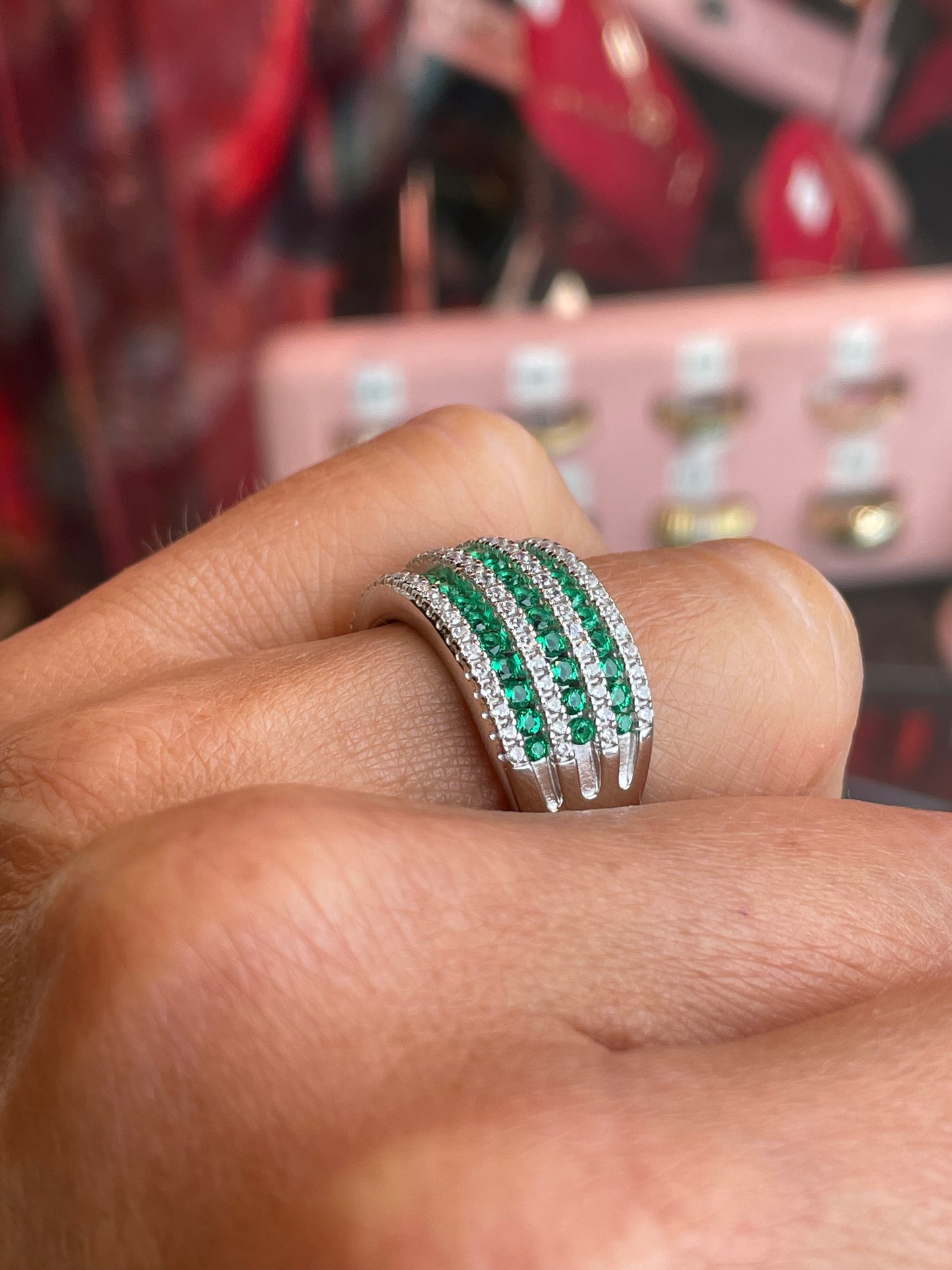 Silver CZ wide band ring with emerald green gemstone from Comero, showcasing a stylish and sparkling jewelry piece.