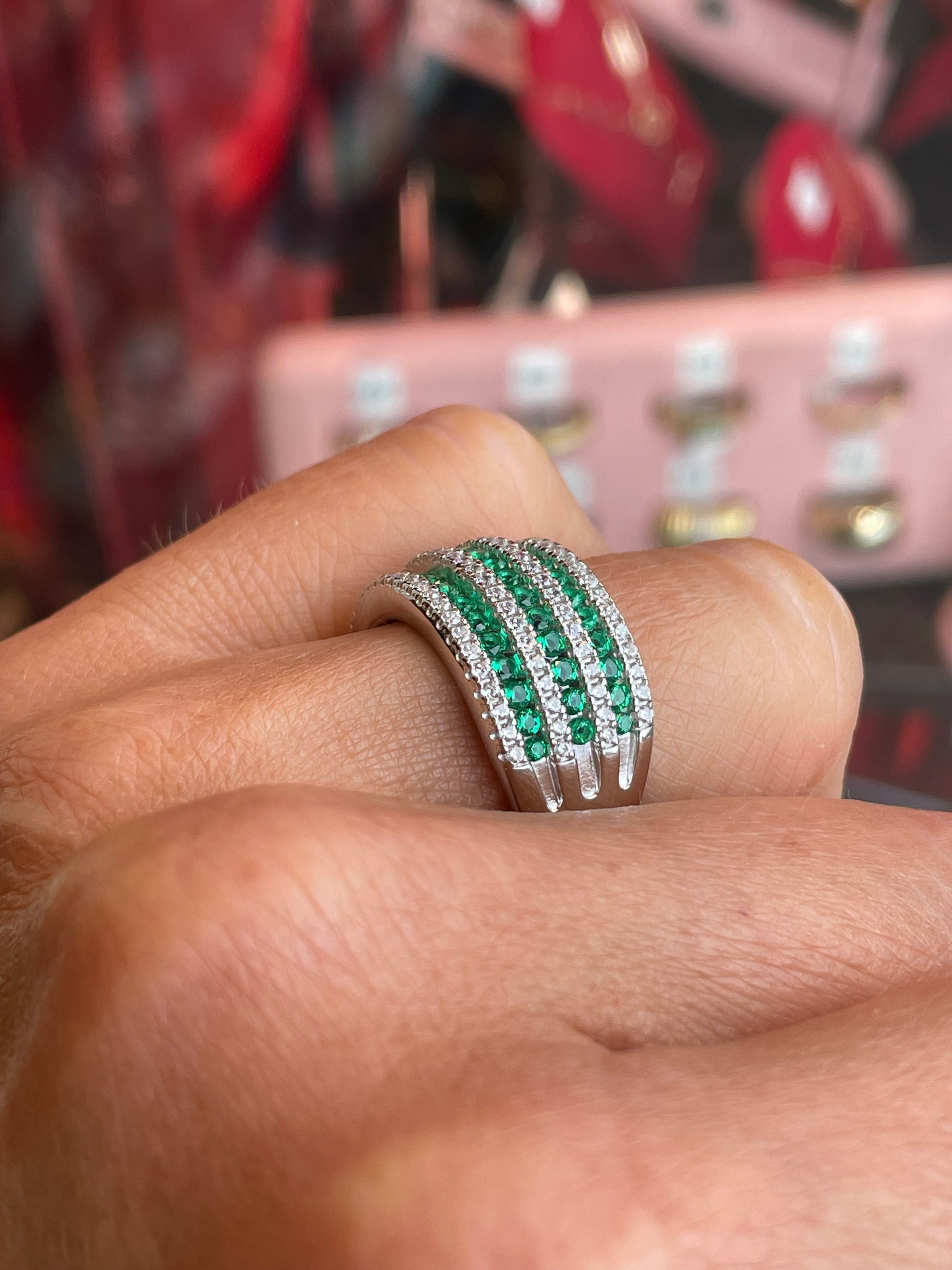 Silver CZ wide band ring with emerald green gemstone from Comero, showcasing a stylish and sparkling jewelry piece.