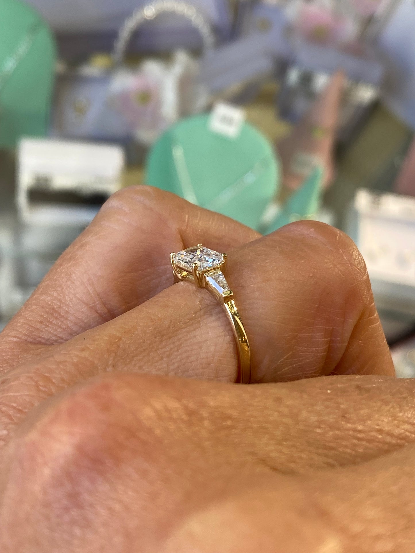 Insignia 9ct gold east-west ring with cubic zirconia center stone, elegant jewelry accessory for women.