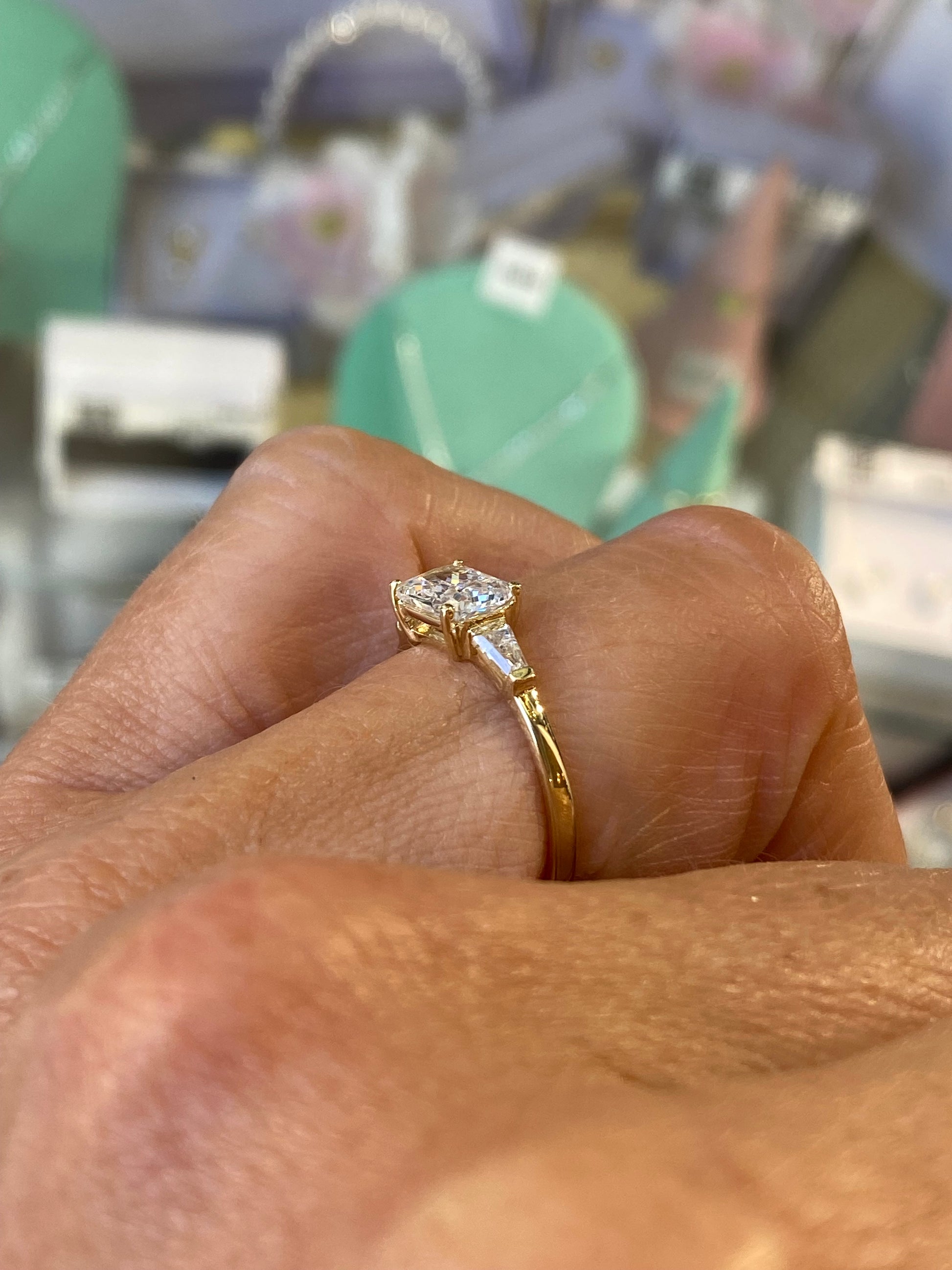 Insignia 9ct gold east-west ring with cubic zirconia center stone, elegant jewelry accessory for women.