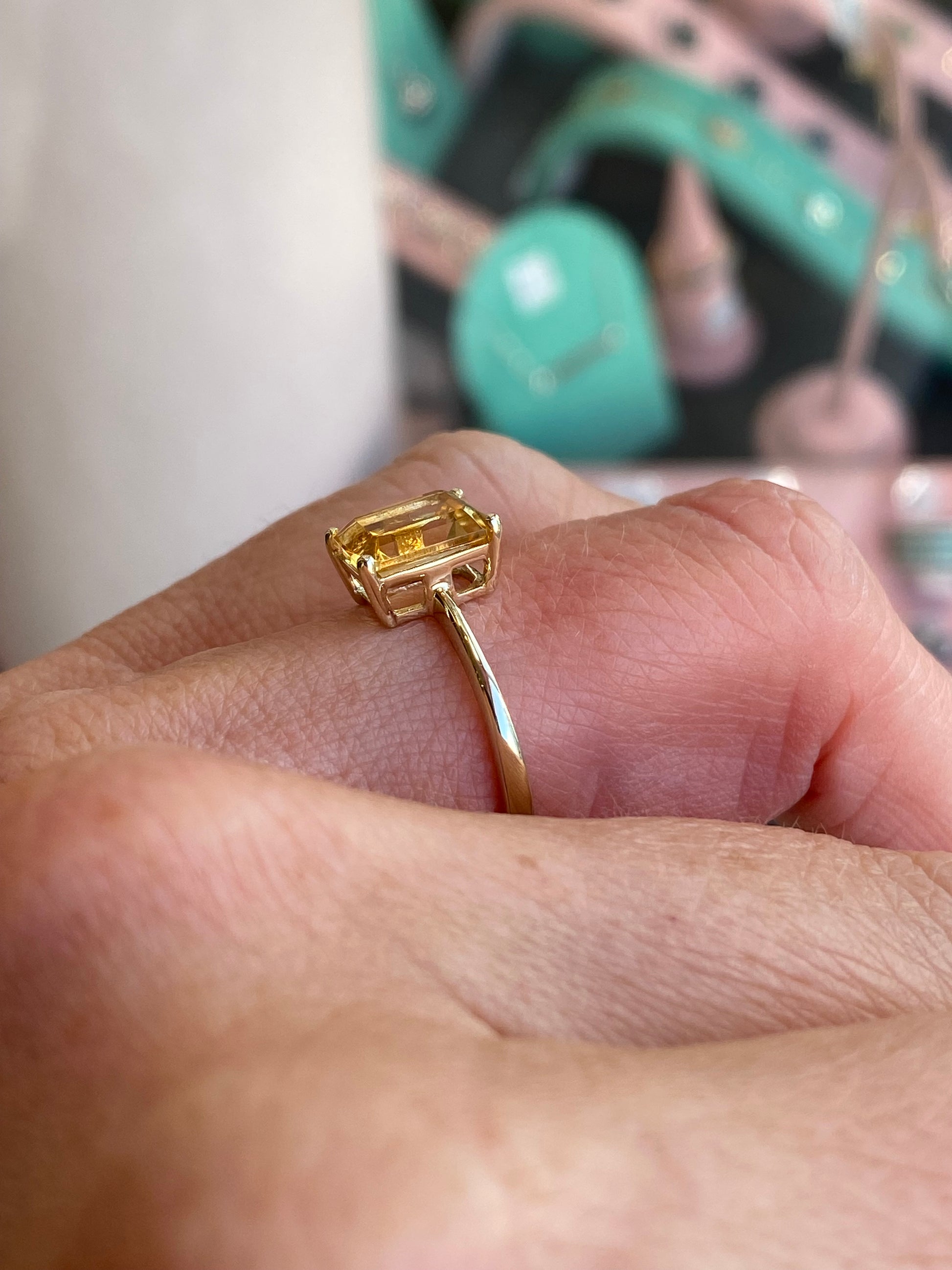 Insignia 9ct gold emerald cut citrine ring showing the sparkling yellow gemstone set in a sleek gold band.