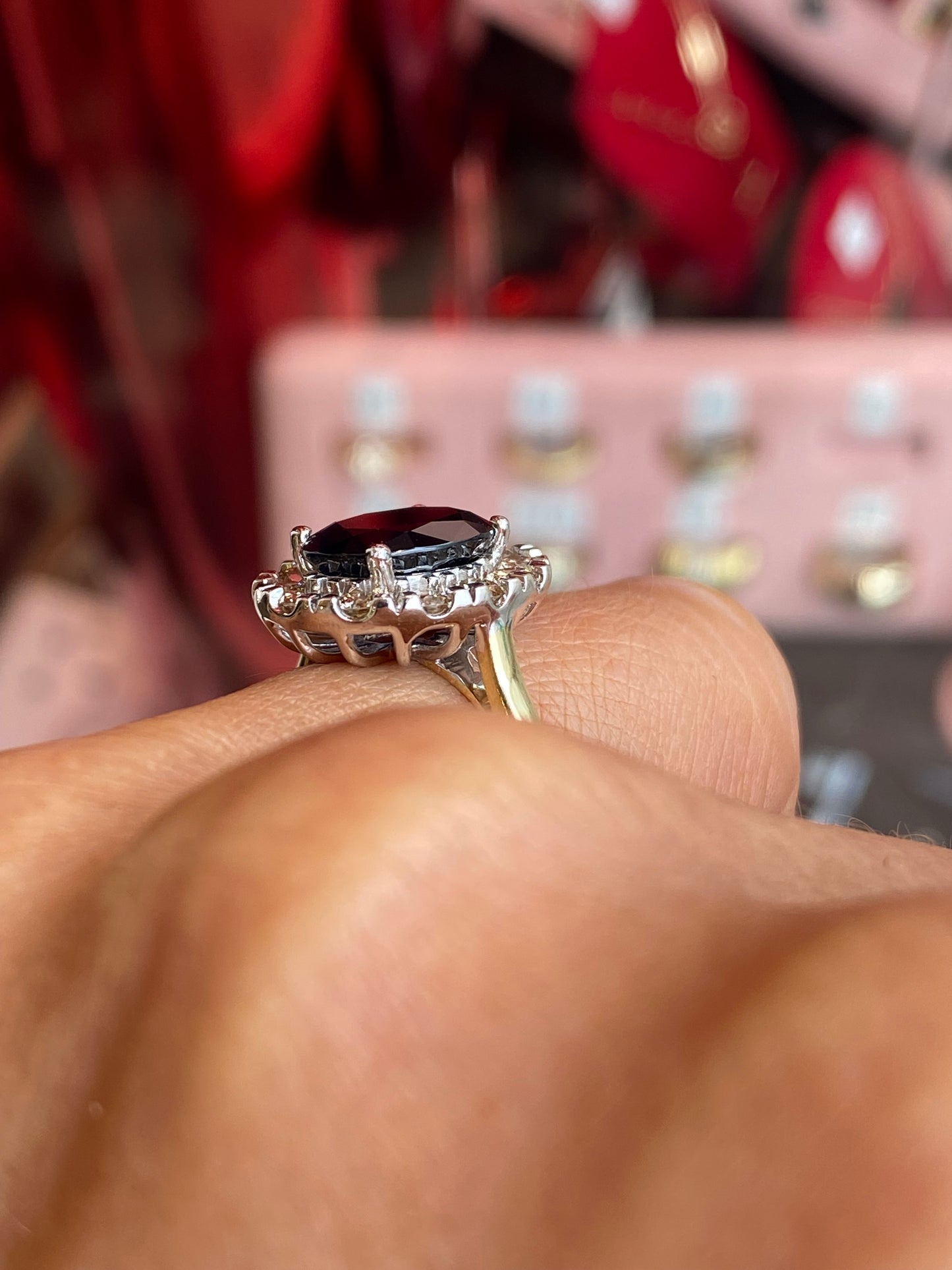 9ct gold sapphire and diamond ring by UJT, showcasing a central blue sapphire surrounded by sparkling diamonds.