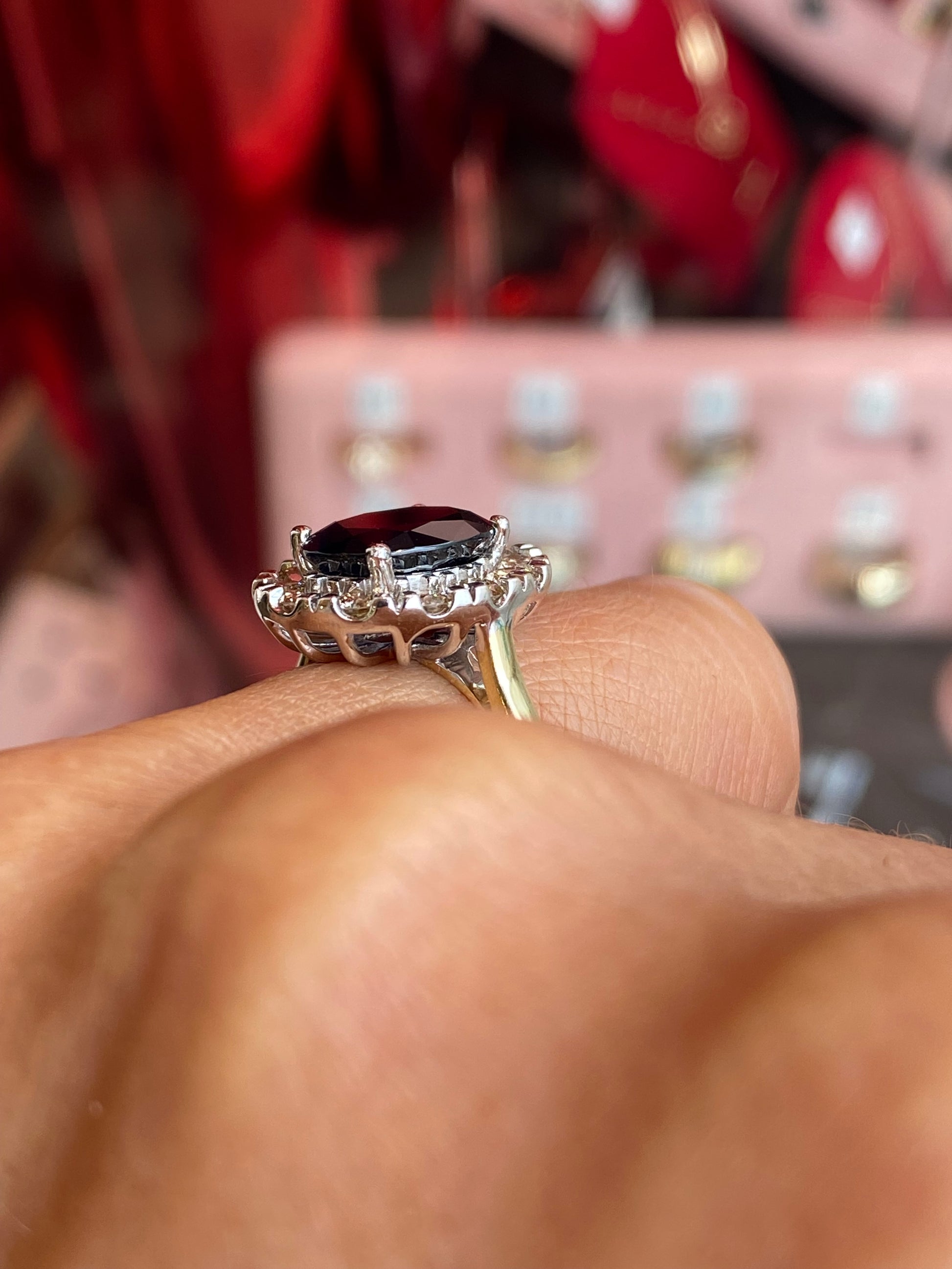 9ct gold sapphire and diamond ring by UJT, showcasing a central blue sapphire surrounded by sparkling diamonds.