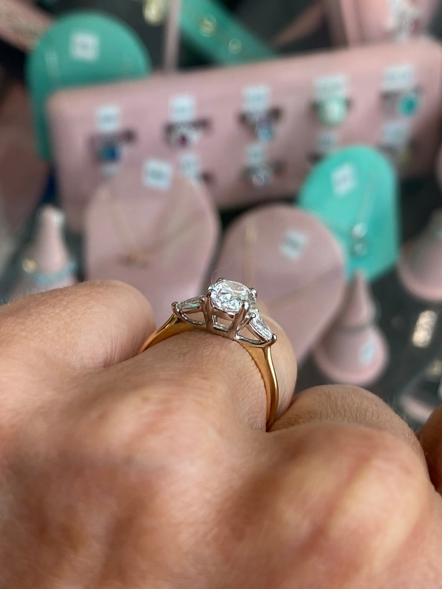 18ct gold trilogy engagement ring by Prima with a 1.84ct certified lab diamond, featuring three sparkling center stones.