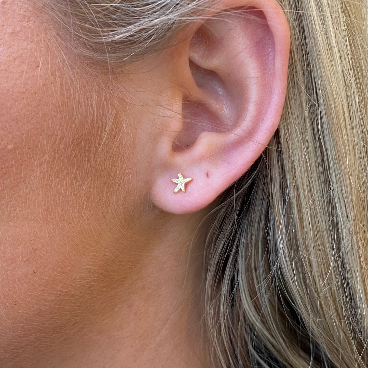 Comero Sunshine CZ starfish kid's stud earrings with sparkling yellow gemstones on silver posts.