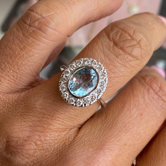 14ct white gold aquamarine and diamond ring by UJT, showcasing a sparkling aquamarine gemstone surrounded by diamonds.