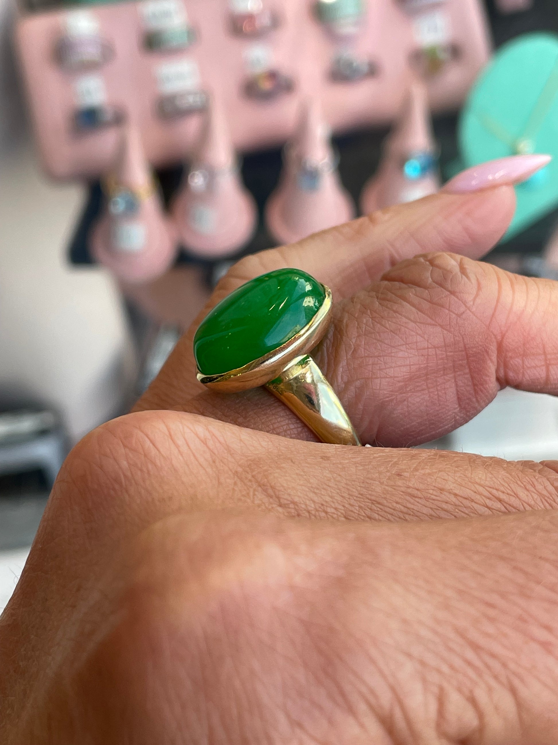 Bruno green jade oval ring with polished gemstone and silver band, showcasing elegant jewelry design.