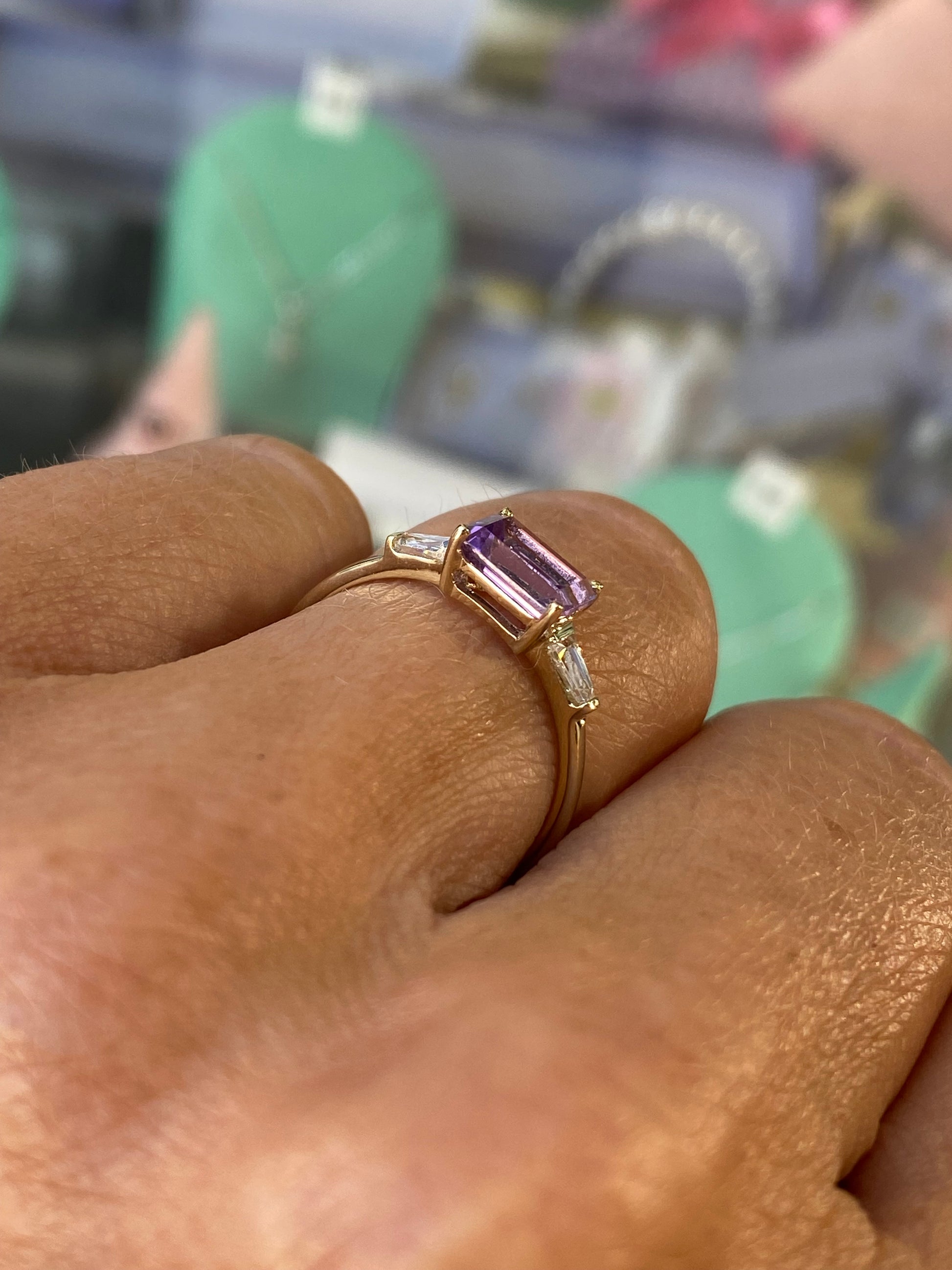 Insignia 9ct gold east-west ring featuring a central amethyst gemstone and cubic zirconia accents.