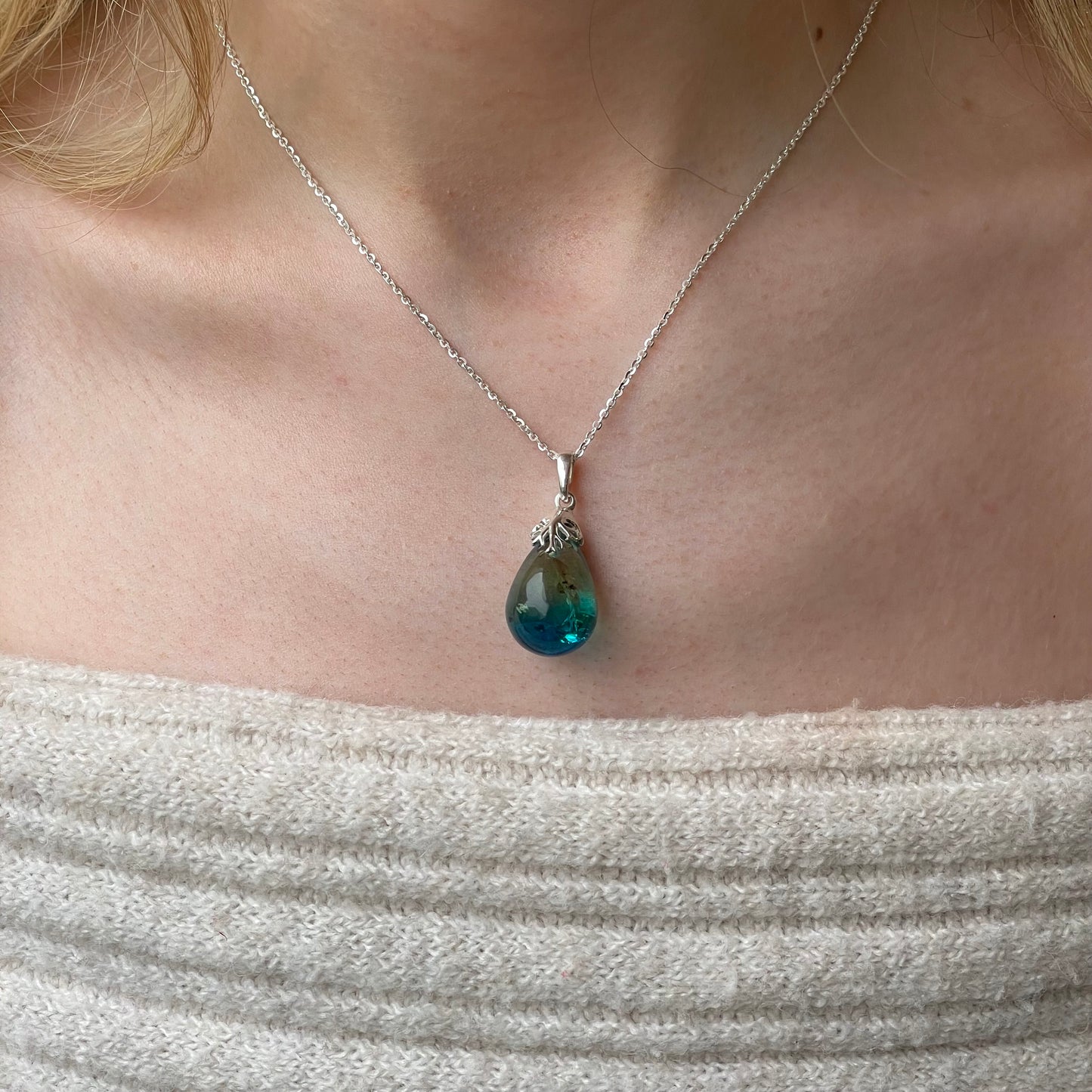 Silver Baltic Amber pendant necklace by CME featuring a polished amber gemstone on a silver chain.