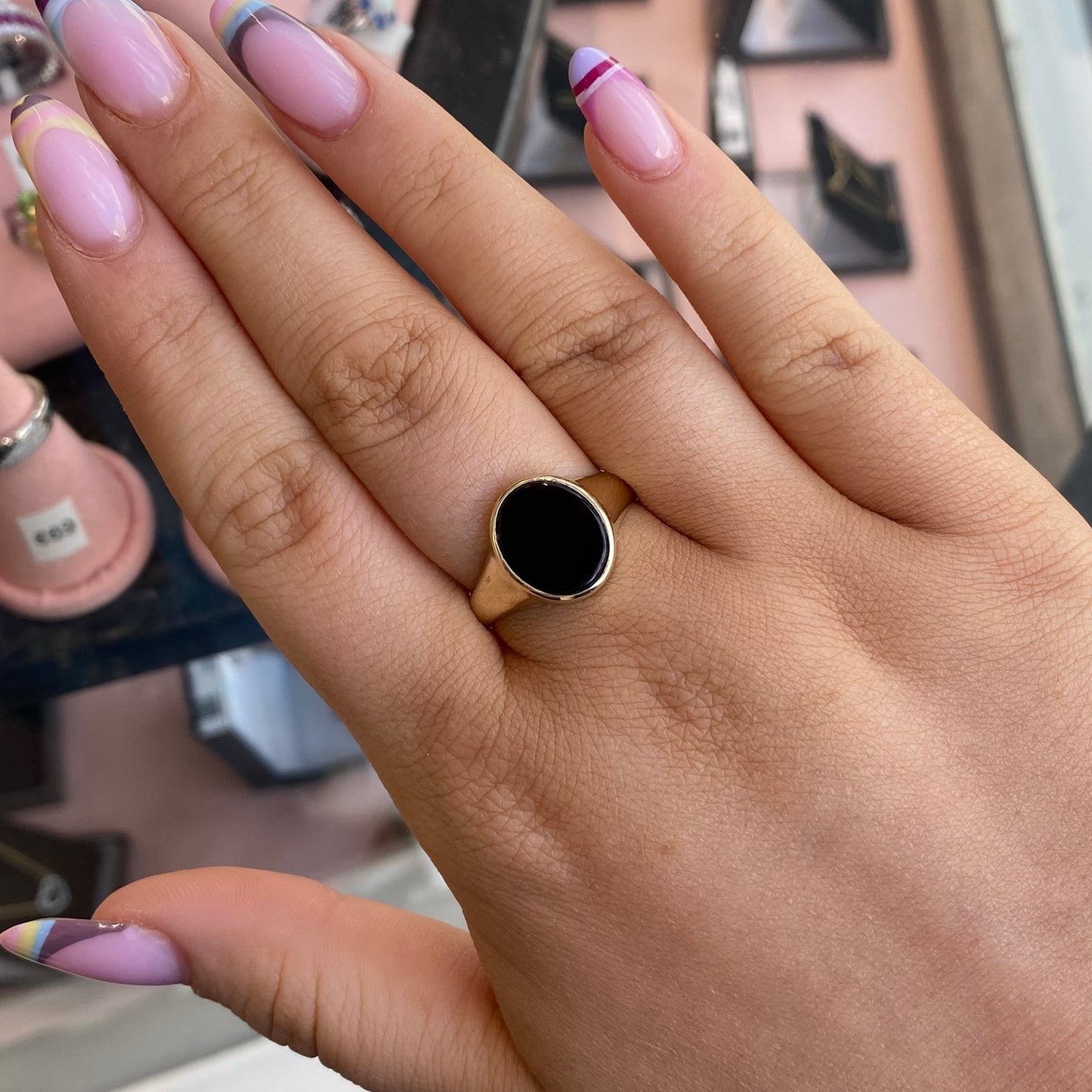 9ct gold men's onyx ring with oval black onyx stone, crafted by PJD, featuring a sleek and polished design.
