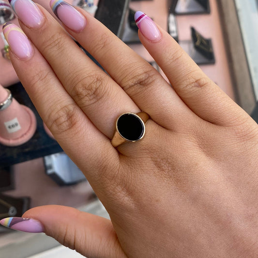 9ct gold men's onyx ring with oval black onyx stone, crafted by PJD, featuring a sleek and polished design.